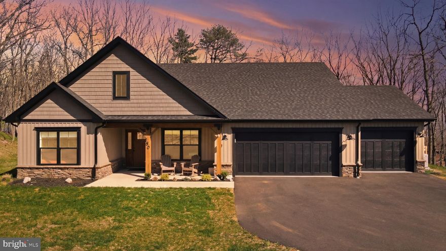 Set on 0.83 acres in The Woods, this contemporary home built in 2025- offers a modern layout paired with a private, scenic backdrop of mountains and woods.

The main living space is open, with the kitchen, dining area, and great room flowing together—ideal for everyday living and easy entertaining. The kitchen has been thoughtfully upgraded beyond builder-grade finishes and features soft-close cabinetry, a large island, and an oversized pantry for added function and storage. A separate dining area provides space for more formal meals, or keep things casual with seating at the island.

The great room is filled with natural light, centered around an electric fireplace, and opens directly into a new three-season sunroom. From there, step out to the fenced backyard—creating an easy indoor-outdoor connection perfect for relaxing or hosting.

The thoughtfully designed layout offers two flexible bedrooms—perfect for guests, a home office, or additional living space—alongside a spacious primary suite complete with a custom-tiled shower with double vanity and a walk-in closet

A dedicated laundry room adds everyday convenience and connects directly to the attached three-car garage, offering both functionality and additional storage.

Ownership includes a transferable Class B membership to The Woods Club, providing access to indoor and outdoor pools, fitness facilities, tennis courts, and more.

If you’re looking for newer construction with meaningful upgrades, a functional layout, and a setting that offers both privacy and community amenities, this home is well worth a closer look.