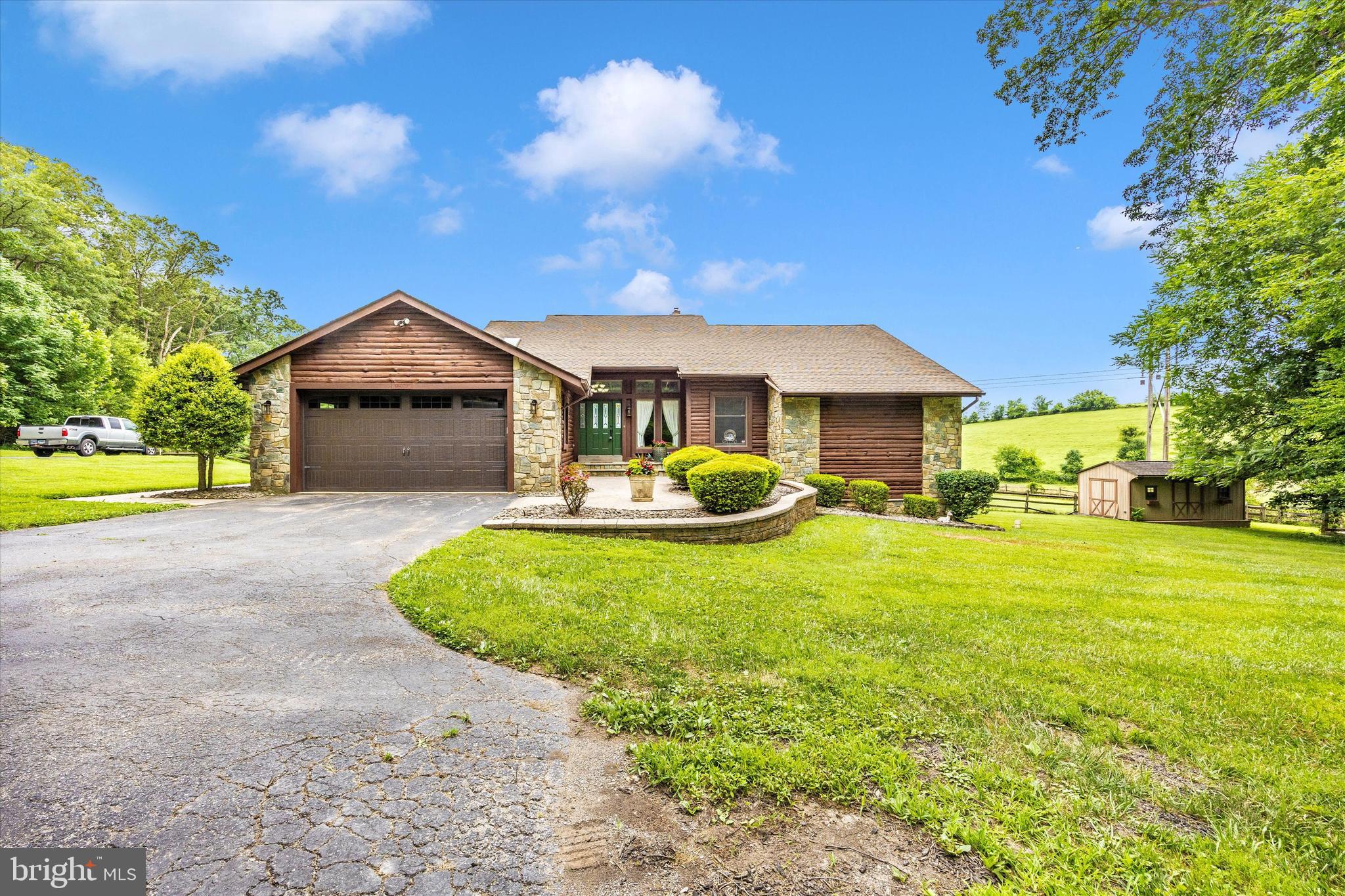 Custom built contemporary rustic ranch-style home nestled at the end of a quiet cul-de-sac and backs to a scenic 100+ acre farm with picturesque country views, including expansive views of the Linganore Winery. Situated on 1.9 acres, this home offers peaceful privacy on all sides of the property. The huge partially fenced backyard is perfect for entertaining, gardening, pets, and play. A huge deck spans the rear of the house that is perfect for sitting outside to take in the panoramic views, enjoying morning coffee, cook-outs and amazing sunsets. Keep your eyes on that awesome view so you don’t miss the deer running through the fields or the bald eagles flying above. Inside, on the main level you'll find vaulted ceilings throughout, hardwood flooring, ceramic tile and new carpet in the primary bedroom. The foyer opens to a spacious great room that boasts a stunning floor to ceiling stone fireplace, sky lights and high-end Andersen windows and sliding glass door that span the entire rear of the room. The sliding glass door opens to the deck that lets that fabulous view and cheerful natural light into the room. The fireplace is currently configured with a propane gas insert but can be converted back to its original wood burning use. The great room flows into the dining area that enters the well-appointed kitchen. The kitchen offers custom 42-inch cherry cabinetry with slide-out drawers, upgraded granite tops, newer stainless-steel appliances including a high-end induction cooktop and skylights that make the kitchen area light and bright. There is a mudroom off the freshly painted 2-car garage that enters into the kitchen with the main level laundry area located conveniently close by. An enclosed 3-season room off the kitchen has rustic log and stone walls and includes a corner hot tub, the perfect quiet place to relax. Down the hall is a large primary bedroom with vaulted ceilings, new carpet and includes a large walk-in closet and an en-suite bath with a jetted tub, vaulted ceilings, huge sky light and separate shower. Two additional well-sized bedrooms and a second full bath provide plenty of space for family or guests. Going down to the finished lower-level you have new carpet on the steps, new wood-plank laminate floors and large windows across the rear of the house that let tons of natural light and serene scenic views into the rooms. A spacious recreation room on the right side includes a rough-in for a future woodstove, a beautiful Olhausen pool table and a third full bathroom, perfect for entertaining. The rec room has a sliding glass door that walks out to the side yard. On the other side there is huge bonus room previously used as a fourth bedroom that includes another generous walk-in closet plus a huge second closet with shelving that offers plenty of storage. Outside, in addition to the huge deck there is a storage shed plus a second covered building built on a concrete slab that was once used as a dog kennel and equipment storage. There is plenty of parking in the primary driveway as well as a separate parking pad complete with electric hook-up and buried dump tank for an RV. Water Heater Replaced 2025, HVAC System Replaced 2020, Well Pressure Tank Replaced 2019, Roof Replaced 2005 with Atlas Pinnacle Pristine 35-year architectural shingles. Close to local breweries, wineries, and conveniently located just minutes from I-70, shopping, and dining, this home offers the perfect balance of privacy and accessibility. Builder's personal home and original owner offered for sale for the first time! Don't miss this opportunity to own a piece of paradise in Mt Airy with no HOA!!! Schedule a showing today and experience all this home has to offer.