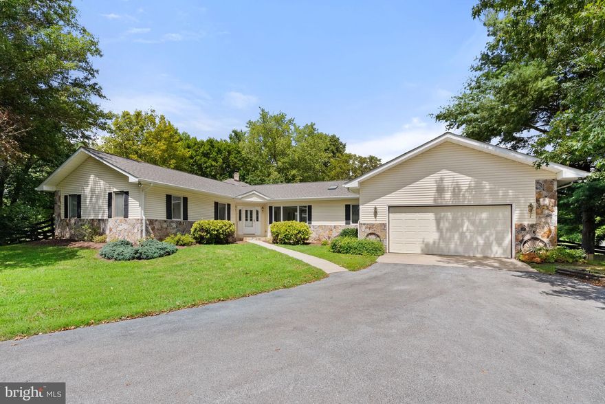 This exceptional estate offers a perfect blend of elegance, functionality, and rural charm. Situated in the middle of 9+ acres of rolling pasture land, this sprawling Rancher is a dream come true for those seeking a place to bring their horses and livestock! The home boasts a spacious family room with a high vaulted wood ceiling and stone fireplace, creating a cozy yet open atmosphere. The kitchen features an island with a breakfast bar, stainless steel appliances, a cooktop plus wall oven, and a large picture window that frames lovely views of the pastures and barns. A walk-in pantry with a skylight, a separate breakfast area, plus a formal dining room provide ample space for kitchen storage, prep, and sit-down meals. Each room is bathed in natural light from large windows, enhancing the home's airy feel. The primary suite is a luxurious retreat, offering a walk-in closet and an extra-large bathroom with a shower and two sinks. The enclosed porch/sunroom with utility sink leads to a greenhouse, perfect for flower enthusiasts or those wanting to grow their own fruits and vegetables. The spacious screened-in porch and rear deck are great for outdoor relaxation or for entertaining guests. Extras include a new roof, a spacious laundry room, a warm propane fireplace, built-in cabinets and desk area in the dining room, multiple ceiling fans, storm doors, casement windows, flood lights, paved walking paths, an oversized two car garage with crawlspace access and attic pull-down stairs, and so much more! Designed for equestrian lovers and homesteaders alike, this property features multiple fenced pasture fields adorned with mature trees, a two-stall horse stable/barn with a feed/tack room, a turnout shed, and another barn/shed. The multi-purpose outbuilding with a finished 15'x11' room could serve as a workshop, studio, office, gym, storage room, etc. The options are limitless!