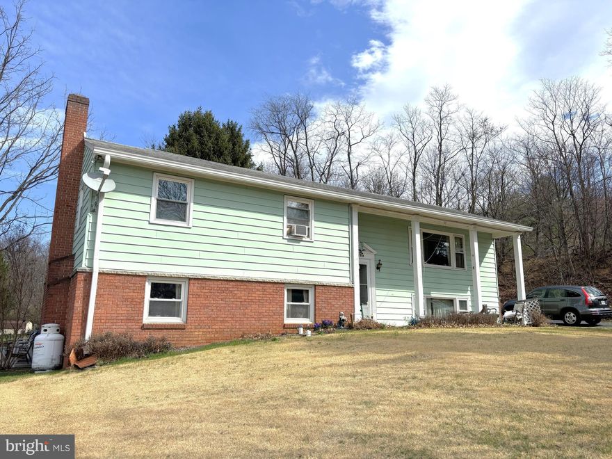 Estate Home being sold "AS-IS".   All appliances are in good working order.  Home is in the process of being cleaned out.   Large split-level 5 bedroom, 3 full bathroom home awaits your personal touches and updates.   In addition to 4  bedrooms, and 2 baths on the main/upper level, is a family room and kitchen/dining room with attached Florida/Sun room.  5th bedroom and 3rd bath in addition to  a large family room with a propane stone fireplace and utility room with walk-out to side/back yard can be found on the lower-level.  Two driveways flank the home for convenient entrances into the sunroom (right) and the utility room (left).  3 storage sheds in the backyard.  Recently appraised.  If a little elbow grease doesn't scare you, this home is the bargain for you!