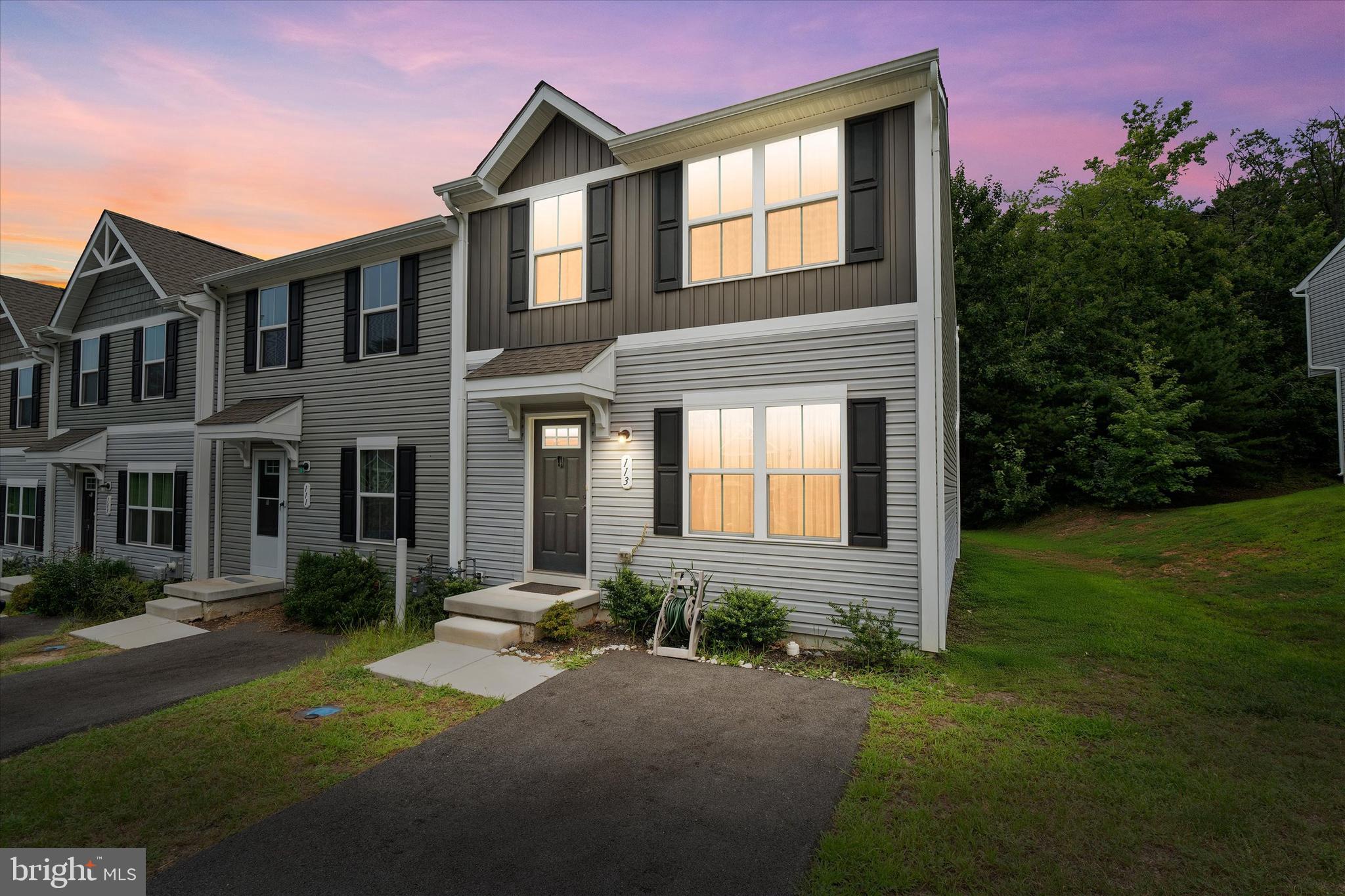 Welcome to this beautifully maintained end-unit townhome offering 3 bedrooms and 2.5 baths in a prime location in community backing to trees for your quiet enjoyment! Only two years old, this home features an open-concept main level filled with natural light and perfect for modern living. The stunning kitchen is equipped with white cabinetry, beautiful granite countertops and stainless steel appliances. The kitchen flows seamlessly into the dining and living areas—ideal for entertaining. Step outside on the maintenance free deck to enjoy some fresh air, relax and read a book, or unwind after a long day. Upstairs, you’ll find a luxurious primary suite complete with a large walk-in closet and a private en-suite bath. Two additional bedrooms, hall bath and 2nd floor laundry complete the upper level. Additional highlights include rough-in plumbing and egress window in the basement to make future finishing a breeze. There are three dedicated parking spaces right in front of the home—no garage needed! With its bright and airy layout, stylish finishes, and end-unit privacy, this townhome is the perfect blend of comfort and convenience. Located close to all major routes for easy commuting, shopping, restaurants and entertainment. Community offers two fully fenced in playground areas for the little ones. HOA covers grass cutting, leaf removal and snow removal on the street, leaving more time to do the things that make you happy! Don’t miss your chance to call it home!