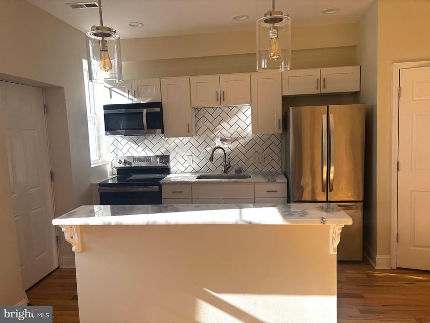 Opportunity Knocks! Move right into this beautifully updated 3-bedroom, 1-bath home that truly has it all! Enjoy an open-concept kitchen featuring granite countertops and modern finishes, perfect for entertaining or family gatherings. The main level boasts gleaming hardwood floors, while the upper level offers newer carpet for added comfort. The updated bathroom adds a fresh, stylish touch. Outside, you’ll love the private backyard parking, plus plenty of additional off-street parking in front. Conveniently located near shopping, dining, and major highways, this home is move-in ready and waiting for you!