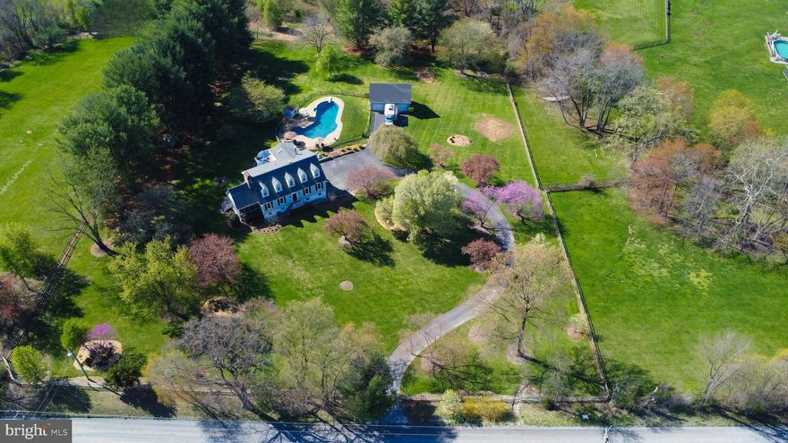 Charm meets elegance in this serene retreat nestled on 3 acres with mature landscaping.  No detail has been overlooked on the presentation of the home.  Come for a tour and you won’t want to leave!
 <br><br>
  
As you enter the property – take a look around and soak in the peaceful setting.  Step out of your car and onto the deck of the 50,000 gallon salt water pool.  The pool ranges from 3-10’ and has a diving board.  Cannonball anyone?  Then turn and take in the 3-car detached garage/workshop with a second floor for storage.  Parking for an RV?  Yes, that’s here too!  What catches your eye next?  The spacious wrap-around deck?  Or the screened porch with its own brick fireplace?  When you walk around the lot, you’ll find a fire-pit, multiple garden areas, and mature trees.  Sun or shade – you can find it all here.
 <br><br>

When you step inside the 2-story foyer, you’ll notice the hardwood flooring throughout this level.  On your left you’ll find a living room with a tiled wood-burning fireplace.  Don’t miss those custom trim details – including square door and window trim, crown moulding, 6’ floor trim, and shiplap accent walls.  You can step out from here onto the screened in porch.
 <br><br>  

Across the entryway, you’ll find the spacious dining room large enough for your busiest holiday meals. 
 <br><br> 

From the dining room, step through the doorway into the breakfast area and kitchen.  The kitchen!  Fully updated with ample quartz countertops, cabinetry, and all GE café stainless steel appliances -- for a truly gourmet kitchen.  Recessed lighting, wall-sconces, and a chandelier provide practical and attractive lighting.  Have you heard that light fixtures are “jewelry” for the home?  Keep looking for those elegant details throughout: here in the kitchen you’ll find cove crown moulding.  The versatile room adjacent to the kitchen is currently in use as an expanded butler’s pantry.  The eye-catching centerpiece of this room is the wood-burning fireplace with the hand-applied German Schmear.   From this room you can also step out onto the screened porch.
 <br><br>  

If you head back into the kitchen and breakfast area, with lots of table space, you’ll enter the sun-filled family room.  From there, you can step out onto the wrap-around deck.  You’ll also find a full bath on this level.
 <br><br> 

Head upstairs to explore the Primary Suite with hard-wood flooring and a sitting area with its own wood-burning fireplace.  Step into the luxurious, sun-filled primary bath with a slipper tub all set for your next fire-side soak.  Yes, that’s a wall-mounted electric fireplace!  Prefer a shower? Just step into the over-sized frameless shower.  The dual split vanity offers the best of both worlds – you can share while still enjoying your own space.
 <br><br>  

Next, explore the renovated upper level hall bath.  Don’t overlook those gorgeous floor tiles which perfectly coordinate with the vanity and the custom shower.  Two more generously-sized bedrooms complete this level.
 <br><br>

The lower level offers a host of options to match your lifestyle.  Here you’ll find a rec room with a newly added kitchenette (with a refrigerator, counter, & cabinetry), a spacious bedroom with a walk in closet, and another full-bath.  Is it the perfect nanny/au pair, teen, or in-law suite?  Game room?  Home office space?  Options abound.  Plus a laundry/mud room with built-in cabinetry for convenient storage.
 <br><br>

The Sellers have renovated this home with an eye for luxury and grace, while creating a warm and welcoming atmosphere.  And, yes, there’s high-speed internet service!