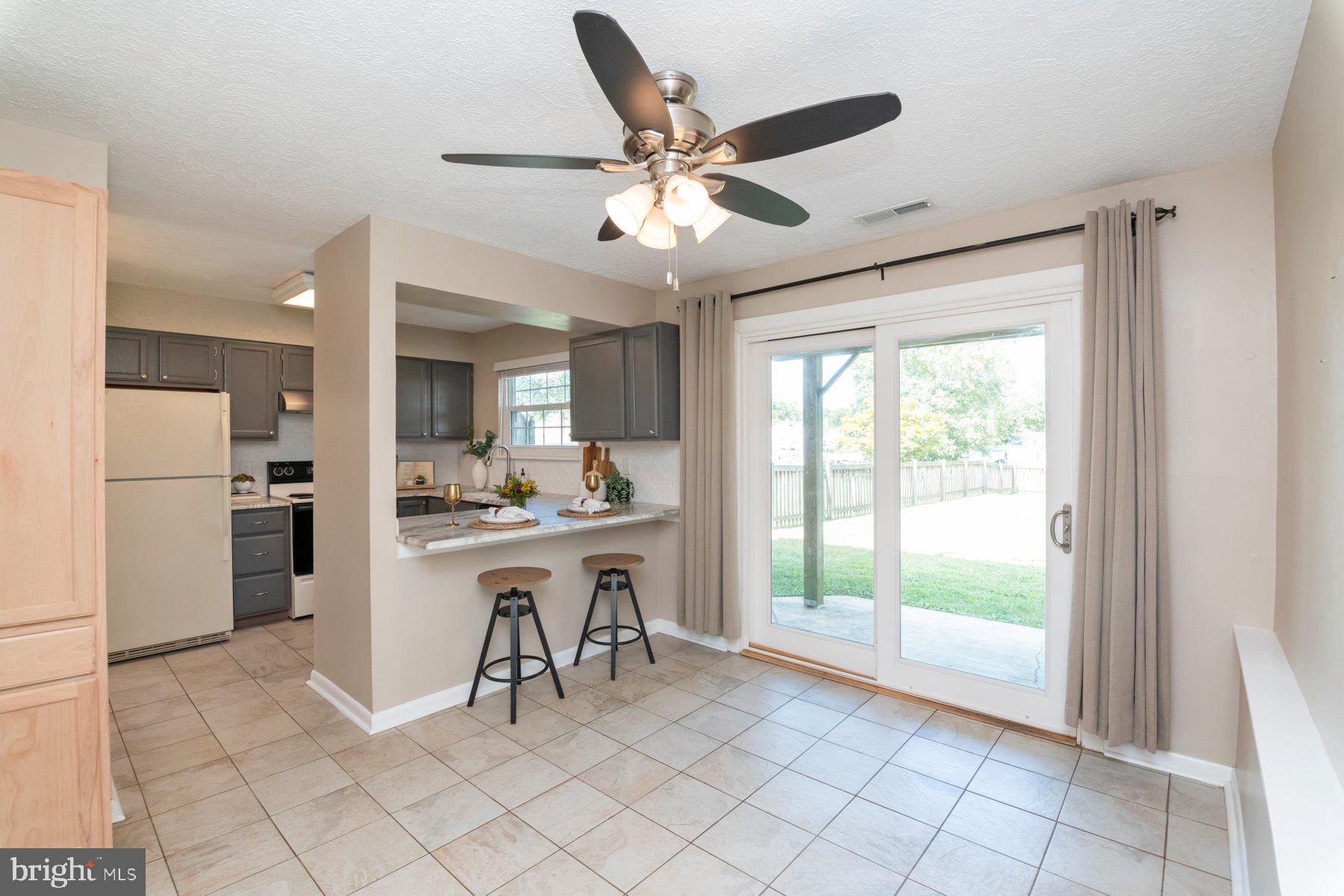 Water views, natural light, and a lifestyle that feels like a getaway every day. This sweet 2-bedroom, 1.5-bath home backs up to the Gunpowder River with community access to fishing, swimming, kayaking, and more just steps away.
The main level features a bright kitchen with a breakfast bar that opens to the dining area, plus a living room filled with sunshine and a fireplace for chilly evenings. Upstairs, the oversized primary suite has a walk-in closet with built-in shelving, bonus space perfect for an office or potential 3rd bedroom, and direct access to a private deck overlooking the backyard. A second bedroom and full bath complete the level.
The flat, fenced yard is ideal for evenings around a firepit or dining al fresco. New roof in 2025. Launch your weekends on the water, then be back to Pulaski Highway conveniences in just minutes. Fishing piers, boat ramps, and endless river adventures are right at your doorstep.