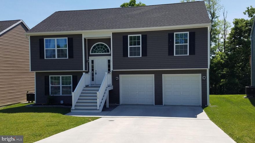 2 year old home in very desirable Charles Town commuter location with access to VA and MD. Home shows well with 4 bedrooms and 3 full baths. Main level has open floor plan with well appointed kitchen, including SS appliances and island. Updated laminate flooring throughout kitchen, dining and living areas. Sliding doors leading to elevated deck. Large garage for 2 cars and extra storage. Lower level has a bedroom and full bath along with additional living space. Taxes are based on pre construction and will adjust to reflect completed dwelling. Square footage is estimated.