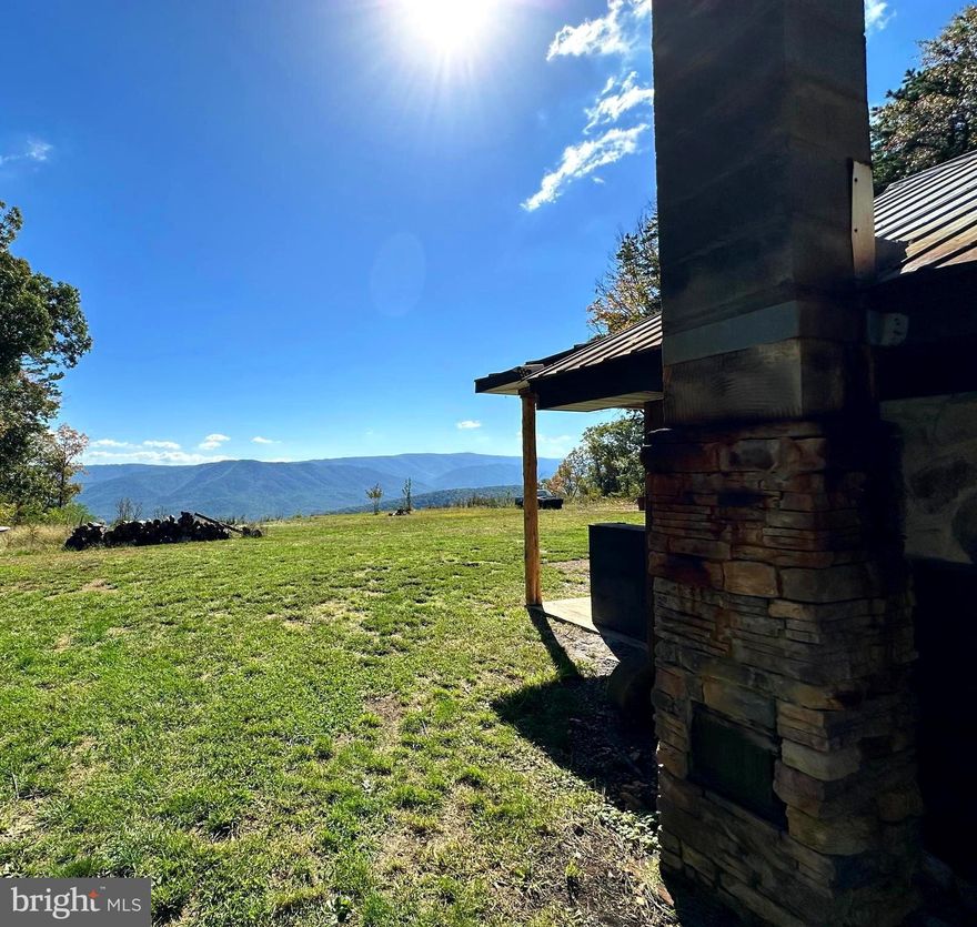 OFF GRID & 4WD/AWD ACCESS advised.  The VIEWS from the front porch of this rustic cabin are absolutely breathtaking!  Sit on the front porch with a favorite beverage and let the theater of nature mesmerize and relax the soul.  Over 22 acres to roam, hike or hunt on terrain that is mildly sloping.  Cabin has kitchen, living area, 2 partially finished bathrooms, a large upstairs bedroom with a spacious balcony and  2 additional bedrooms.  Large tree stand will convey for watching the animals stroll by.  Want a complete, off grid homestead, this may be the place for you!  You and some hunting buddies looking for a camp, this may be the property for you.  Want a retreat that has a MAJESTIC VIEWS, SECLUDED, totally OFF GRID and you don't mind traveling the narrow way to the property, this may be the cabin for you.  For this property, OFF GRID means 1) no electric service available  2) Generator and solar power on premise 3) No internet and very limited cell service which varies by carrier.  Satellite service may be possible.  4) No water source. Water holding tank only  5) Septic on site but owner has no knowledge of the system.  Get back to the slower life, call today to see the property.