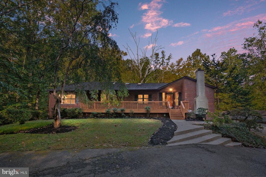 There’s a kind of peace you can’t fake—the kind that meets you the moment you turn down River Road. Sunlight filters through the trees, and suddenly, the noise quiets. The world slows down. That’s what life feels like at 1496 River Road.

Set on 1.47 acres of wooded serenity, this 4-bedroom, 3.5-bath home invites you to breathe again. The open-concept main level is filled with natural light pouring through skylights, creating that effortless blend of comfort and connection. Imagine morning coffee on the deck as the forest wakes up around you, or evenings where French doors from the primary suite open to nothing but birdsong and stillness.

It’s not just a home—it’s a blank canvas for your next chapter. The bright kitchen offers space to reimagine and refresh. The primary suite, already a retreat, can become your personal sanctuary. And downstairs, the flexible lower level opens doors to possibility—a creative studio, a fitness haven, or the ultimate guest suite.

Outside, the story continues. A 1,300+ sq ft detached garage sits tucked away—ideal for a workshop, a collection, or your next big project. Every inch of this property is designed to evolve with you.

Moments from Annapolis and major routes, yet worlds away from the rush, this is where you come to reconnect—with nature, with family, with what matters.

Welcome home—where tranquility meets transformation, and the next version of “you” is waiting to move in.