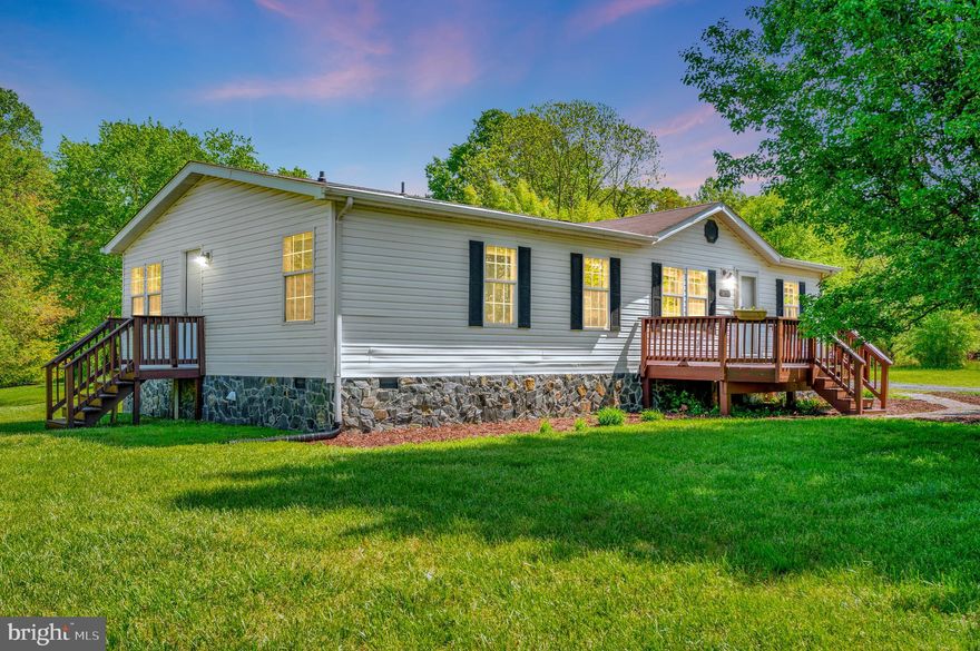 Welcome to your slice of serenity! Nestled on just over 2 acres of quiet, private land in beautiful Locust Grove, Virginia, this charming 3-bedroom, 2-bath modular home offers the perfect balance of comfort, space, and rural charm.

With 1,344 finished square feet, this well-maintained home is move-in ready and full of thoughtful updates, including a newer HVAC system to keep you comfortable year-round and fresh paint on both the front and rear decks—perfect for relaxing with your morning coffee or hosting weekend cookouts.

Step inside to find a spacious living room that flows into the open kitchen and dining area, complete with plenty of cabinet space and natural light. The primary suite features a full en-suite bath and generous closet space, while two additional bedrooms provide flexibility for guests or a home office.

The property offers over 2 acres of level, usable land—ideal for gardening, chickens, or simply enjoying wide open space with no HOA restrictions. The private setting gives you room to breathe, play, and unwind, all while being just a short drive to Locust Grove, Culpeper and Fredericksburg.

Priced well below market - this is a home you don’t want to miss!