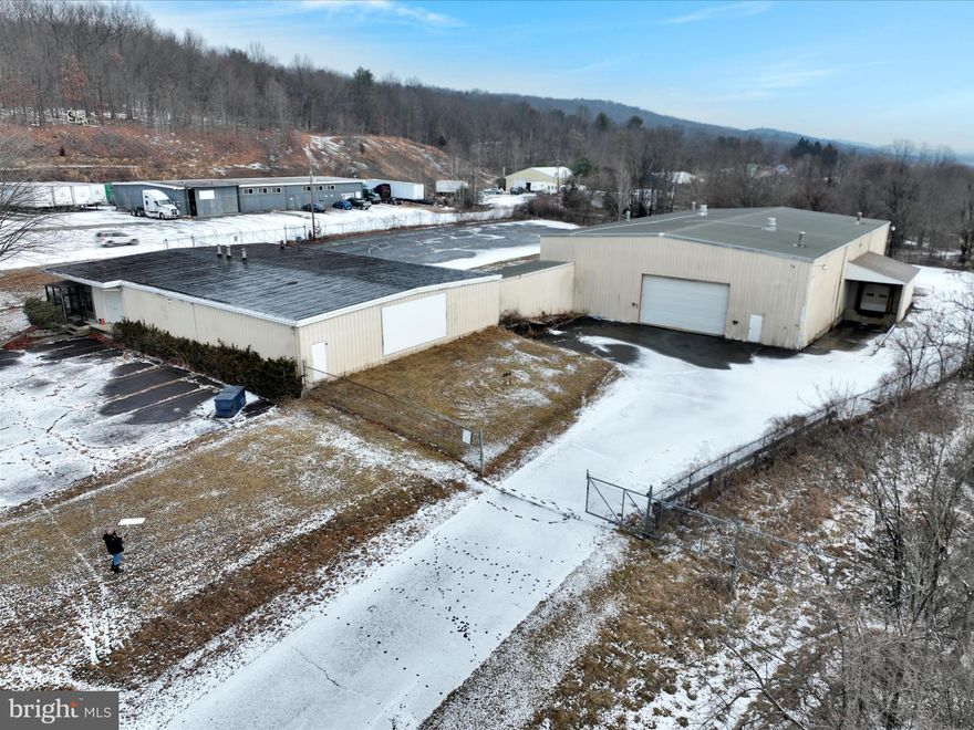 Discover unparalleled potential in this impressive 17,000 sq ft climate-controlled warehouse, ideally situated on over 2 acres of prime real estate. With soaring 24ft ceilings, 14ft overhead doors, multiple loading docks, and convenient drive-in entrances, this facility offers versatility and efficiency—it's even spacious enough to accommodate aircraft. Once the renowned Pepsi Cola bottling plant, the building now presents enormous opportunities for a variety of uses, featuring dedicated office space, comfortable bedrooms, and full bathrooms for employees and owners alike. The property also boasts a fenced, secured yard, ample paved parking, and direct access to Route 61, with proximity to highways 78, 80, 81, and 209. Schedule a showing today!