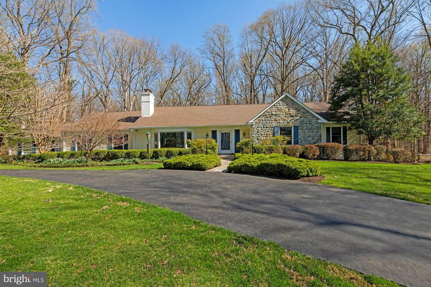Stop your search!  Looking for one level living??!!   It's here...a home  and garage all on one level  with only three steps to enter the front door.   This charming, well maintained, stone and frame home is beautifully sited on over 3 acres in coveted Potomac Falls with easy access to the C &O Canal.  The low maintenance, almost fully wooded, private, bucolic setting is a dream, landscaped with hundreds of spring daffodils!  Let go of your stress and relax in the gazebo or on the back flagstone terrace.   Inside enjoy wonderfully proportioned rooms including a Great Room addition with room for a billiard table, eating area, and gathering space with a fireplace.  The main level has the standard formal rooms PLUS a large home office/study with a fireplace and room for two or more people working from home.  Bird feeders outside the study window will entertain you for hours.  The location close to the C&O Canal offers a wonderful panoply of birds.  This home boasts a Main Level Owners Suite with a large full bathroom and walk-in closet.  In addition, there are three more main level bedrooms and two full bathrooms.  The walk-up attic has great potential if you desire more finished square footage.  There's a partial, unfinished lower level, too.  Enjoy the peace, privacy and low maintenance living you have been desiring!!