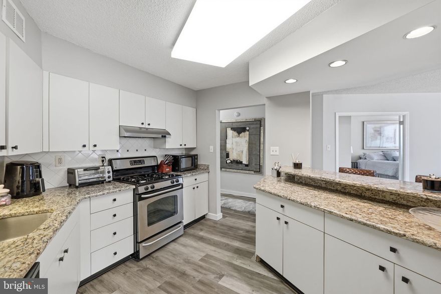 Welcome to 1401N a magnificent apartment with amazing double exposure offering both a beautiful view of the outdoor pool as well as the view over the portico to the trees. The apartment is notable for the very large windows in every room.  The apartment floor is luxury vinyl except for the bedroom which is carpeted.    Walk into the foyer where there is a huge closet.  The mirror and shelf convey with the unit.  The kitchen is particularly large and open.  There are granite counters on two opposing sides of the kitchen, beautiful white cabinets, stainless appliances and a refrigerator with ice maker.  One of the counters is also a breakfast bar with seating.  The living room leads to the oversized balcony with the wonderful pool and treed view.  There is also a built-in cabinet which could be a bar or other storage.  The large bedroom has potential for track lighting, crown molding, linen closet and two clothes closets.  The spacious bathroom houses a clothes closet, a sit down make up area, a large vanity and sizable walk-in shower.  There is lots of overhead lighting in the ceiling. 
The building has so many amenities, it lives like a resort. The lobby is in the process of a complete renovation.   The recently redecorated Arcade level has the state of the art fitness center with indoor pool and hot tub: locker rooms with showers and sauna.  Also in the Arcade is Chef Tony’s restaurant (a well known seafood/Italian eatery), a grocery store/deli, dry cleaners, travel agent, beauty salon, resident lounge, party and conference rooms.  There is a large outdoor pool with adjacent grills.  Tennis (lighted courts) and pickelball have their own building as you drive onto the property.  Ping pong is played regularly, as are social activities such as “Breakfast at Wimbleton”.  There are too many activities to mention them all.  A few are …trivia night, open mike night, monthly first fun movies, lectures, vaccinations, vote in all elections in the party room (including Presidential).  There is meditation, exercise class, book club, canasta, bridge, and mahjong.  We have wine and cheese get togethers in the lobby, a rocking New Year’s Eve party and various other celebrations.  We have car charging stations, and a car washing area with a dynamite vacuum.  Garage parking comes with the unit.  It is easy to get to the Red Line Medical Center metro stop at NIH/Walter Reed.  The bus comes to the door of the Promenade.  Close to 495 and 270.  Nearby Wildwood Shopping Center has Balduccis, CVS, Bethesda Bagels, Starbucks, a number of places to eat and several cute boutiques.  Giant food is just across the street.