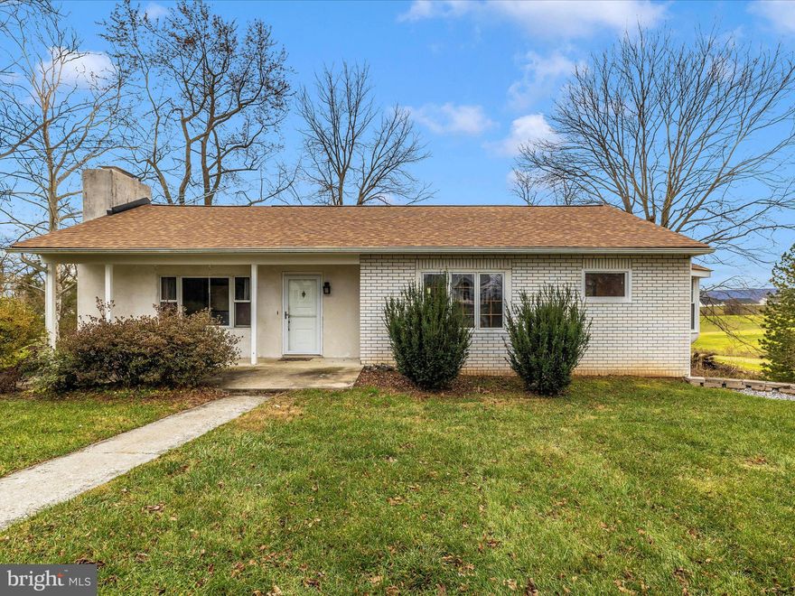 COUNTRY RANCHER With WALK-OUT LOWER LEVEL IN-LAW SUITE W SECOND KITCHEN HAS CUSTOM HAND MADE DETAILS THAT REFLECT THE LOVE AND CARE SELLERS HAD FOR THE HOME! PARK ON CIRCULAR DRIVEWAY AND WALK UNDER ARBOR TO FRONT PORCH. SEE THE PORCH SWING? HEAVY SOLID WOOD FRONT DOOR GLIDES OPEN. HARDWOOD FLOORS, HAND MADE DOORS INSIDE WITH SPECIAL KNOBS AND TOUCHES. BUILT IN SHELVES, PANTRY, COUNTRY BARN BEAMS ADD CHARACTER, CHARM AND HISTORY.   THREE BEDROOMS AND ONE FULL BATH ON MAIN LEVEL. LOWER LEVEL HAS EFFICIENCY KITCHEN, WASHER/DRYER, FULL BATH, AND 4TH BEDROOM. REAR YARD TREES FOR AFTERNOON RELAXATION IN THE SHADE, JUST BEYOND THE GARDEN GATE IS A GOLDFISH POND!  IN 2019 NEW ROOF AND RETAINING WALL.  Primary heat source is heat pump. Back-up heat is oil.  Buyer must verify room and SF measurements. SCENIC VIEWS OF CORN FIELDS, TREES AND MOUNTAINS BEYOND!! FOLLOW THE PATH TO YOUR DREAM LIFE. YOU ONLY LIVE ONCE, MUST SEE THIS HOME!