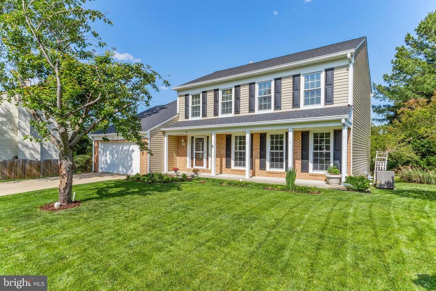 Welcome Home!  This beautiful 3-level, 4-bedroom colonial home is situated on a cul-de-sac and is not to be missed!  This home welcomes you with a covered porch…that only adds to its charm and curb appeal!  When you enter the home, you are greeted with a large open foyer that showcases classic decorative wall trim and hardwood floors that flow throughout the family room and kitchen!  The living room and dining room have been updated with modern wood flooring.  The living room is spacious with plenty of natural light and opens to the dining room that features a picturesque bay window!  The eat-in kitchen offers a functional layout that features stainless steel appliances, a gas stove, pantry, and an island for extra storage and counter-space.  Off the eat-in kitchen is the family room that features shutters, a brick surround gas fireplace, and built-in bookcases!  The primary en-suite bedroom is generous in size and features a vaulted ceiling, large walk-in closet and its own private full bathroom!  The primary bathroom showcases skylights, an extended double vanity, separate shower and soaking tub.  But wait…there’s more!  The basement features a recreation or 2nd family room and a bonus area that can be used as a workshop and/or storage.  The backyard boasts a low maintenance 2-tier Trex deck that is a wonderful area to enjoy outdoor living!  Conveniently located near shopping, grocery stores, I-95, VRE, commuter lot and more! This home is freshly painted, has new carpet, newer roof, newer siding and so much more!  Do not miss out!