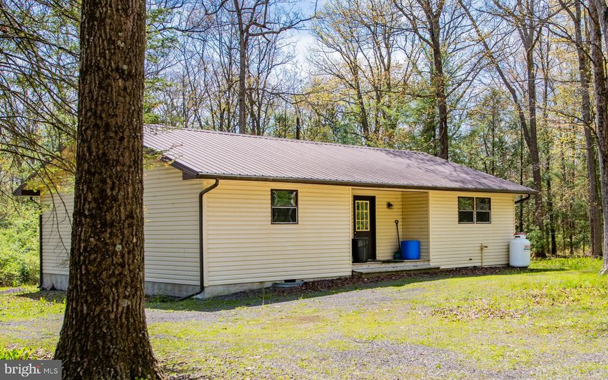This Ranch in a beautiful setting in the woods could be a Seasonal Get Away or a Full time Residence. There are 2 bedrooms and 1 Large bathroom with lots of knotty pine walls. Electric heat and a Wood Burner make this open Floor plan easy to heat.
