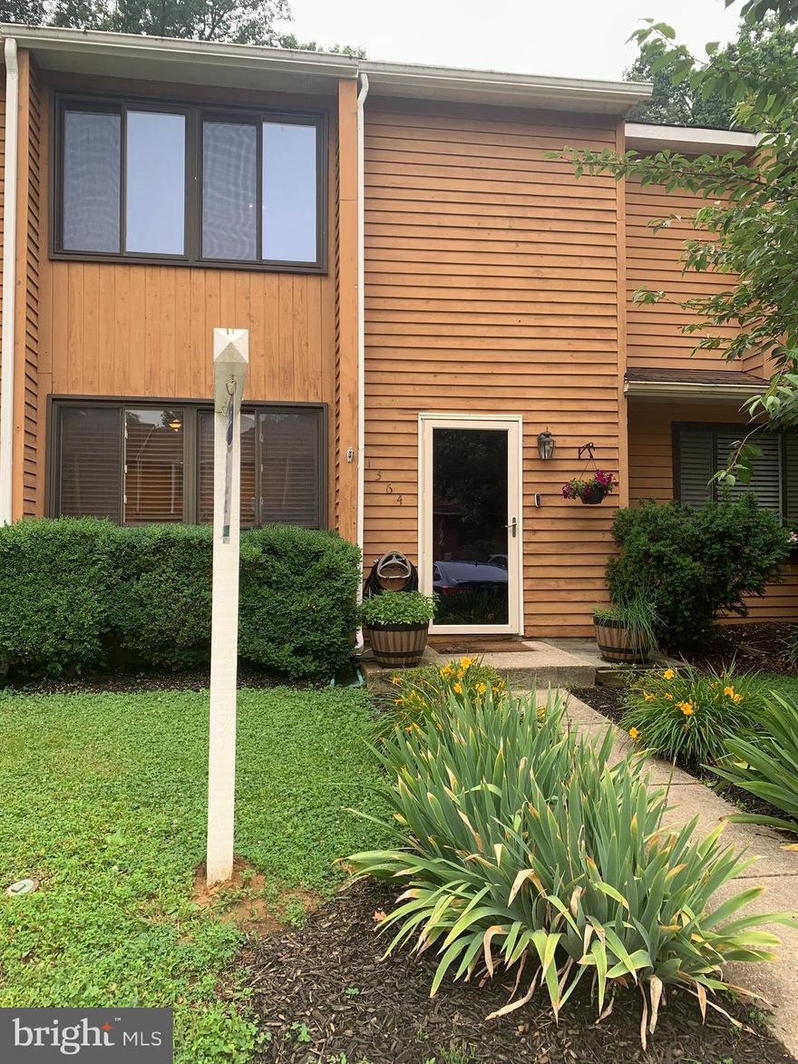 Welcome to 1364 Almond Drive in the heart of the sought-after Walnut Ridge community! Veterans—VA assumable loan 2.9%. 
This three-bedroom, one-and-a-half-bathroom townhome blends comfort, convenience, and charm in a peaceful Annapolis setting. Step inside to a bright, spacious kitchen adorned with ample counter space, a custom backsplash, and newer stainless steel appliances, including a refrigerator. The upgrades include a new roof with new gutters and gutter guards, recessed lighting, a new water heater, and low-flow toilets. The washer and dryer from 2020 simplify the laundry process. Included is a Hotpoint 6.9-cu ft chest freezer. The property comes with a Buyer Home Warranty. The inviting family room flows seamlessly into the private backyard, featuring an oversized deck and a beautifully landscaped garden with flagstone accents—a perfect space for hosting gatherings or enjoying a quiet evening outdoors. Best of all, your private backyard backs to a serene wooded common area, offering privacy and a tranquil view.
Upstairs, you'll find the primary bedroom, two additional bedrooms, and a full bathroom—ideal for a growing family, a home office, or guest accommodations. The pull-down attic ladder provides access to abundant storage space, helping keep your home organized. Dog-friendly park with a playground, swingset, and basketball court.
Located just steps from the Cape St. Claire shopping center, you'll enjoy convenient access to dining, shops, and essential services. Outdoor enthusiasts will love being minutes from Broadneck Park, the B&A Trail, and Sandy Point State Park, with a direct path to the Broadneck Library and Bay Dale Shopping Center. Plus, you're only a short drive from downtown Annapolis, Route 50, and the Bay Bridge.
With fresh paint and updates throughout, this Walnut Ridge gem is move-in ready. Don’t miss your chance to own this exceptional home in a fantastic community.  Welcome Home!
