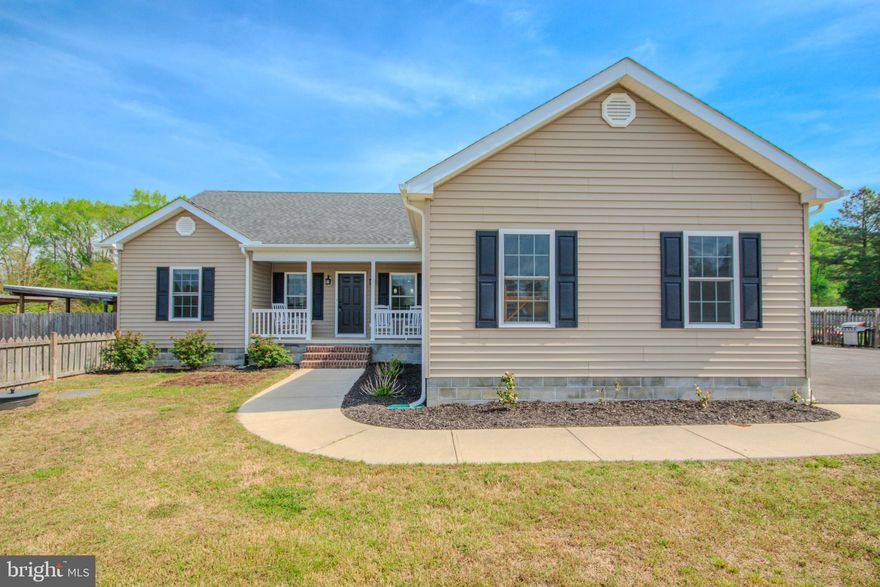 Welcome to 9243 Mill Branch Rd in Mardela Springs! A well-maintained 3-bedroom, 2-bathroom home offering 1,556 sq ft of comfortable living space and THREE full acres of land. Step inside to a living area that showcases vaulted ceilings and a cozy gas fireplace, creating an open and inviting atmosphere. The kitchen is equipped with tiled flooring, granite countertops, and stainless steel appliances, offering both style and functionality. The primary bedroom suite includes a walk-in closet and a luxury bathroom featuring a 6-ft Jacuzzi tub, separate tiled shower, and a double vanity with granite countertops. Two additional bedrooms are located across the living room and share a full bathroom with a tub and shower combination and a granite vanity. This property features 6-ft wooden fencing in both the front and backyard, providing privacy and security. Additional features include a utility room with washer and dryer, pull-down attic access for storage, and a finished garage with a mini-split system, ideal for a workshop, gym, or additional flex space. This home combines comfort, thoughtful layout, and desirable upgrades... Ready for its next owner to move right in! Schedule your private showing today.