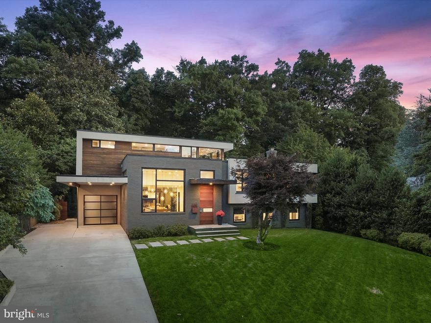 LIVE IN A WORK OF ART! Enchanting one-of-a-kind modern home built in 2012. and spanning 4164 sf, perfectly "right-sized". Chosen for the privacy of this location backing to woodland (and a trail to Whitman HS), this exceptionally beautiful, landscaped lot was the ideal place for the owner to build their Robert M. Gurney inspired dream home. Stunning “great room” with 12 ½ ft ceilings providing gorgeous views to the back garden and treed canopy. The chef's kitchen with Miralis cabinets and custom rift sawn bar and Ceasarstone island, high end appliances including built-in column fridge and freezer, Miele double ovens (speed and convection), double drawer Fisher Paykel dishwasher and second DW in the island. Beautiful living room with fireplace with random width stone surround and wall of glass taking in the view of the trees and garden. Sliding doors lead to a lovely deck. Large dining room with  delightful six globe randomly hung chandelier.  Mudroom with built-in cubbies and coffee bar complete this level. 

The primary bedroom is a dreamy retreat up the "stair tower" with generous windows lighting down several levels of the custom floating staircase. With generous windows taking in the sky and trees,  a yoga/meditation loft and private terraces off the bedroom and the spa-like primary bath, you will delight at waking each morning and retreating each evening to this gorgeous and serene space. The driftwood inspired primary bath has  a sauna, Porcelanosa soaking tub, separate shower, floating custom vanity and opens to the gorgeous fitted walk-in closet.  3 additional bedrooms and 2 gorgeous modern bathrooms and laundry room are also on the upper levels. 

Both the great room level and  walkout family room level have doors leading to the gorgeous "outdoor living room" with fireplace, skylights, ceiling fans and a wet bar. This gives onto a sport court which can expand your entertaining area for parties. On the walkout level you have a huge office or additional bedroom with separate entrance and a full bath with shower. The lowest level offers a large exercise room and double doors leading to a large storage and utility room. 

Carport, mini-garage for bikes, motorcycles and outdoor equipment. Burning Tree/Pyle/Whitman cluster.  A stones throw from schools, shopping, dining, parks, trails, playgrounds, transportation, and a short drive to downtown DC, downtown Bethesda, NOVA, 270 corridor and more. Ride-On to Metro just 0.3 mi away on Whittier.