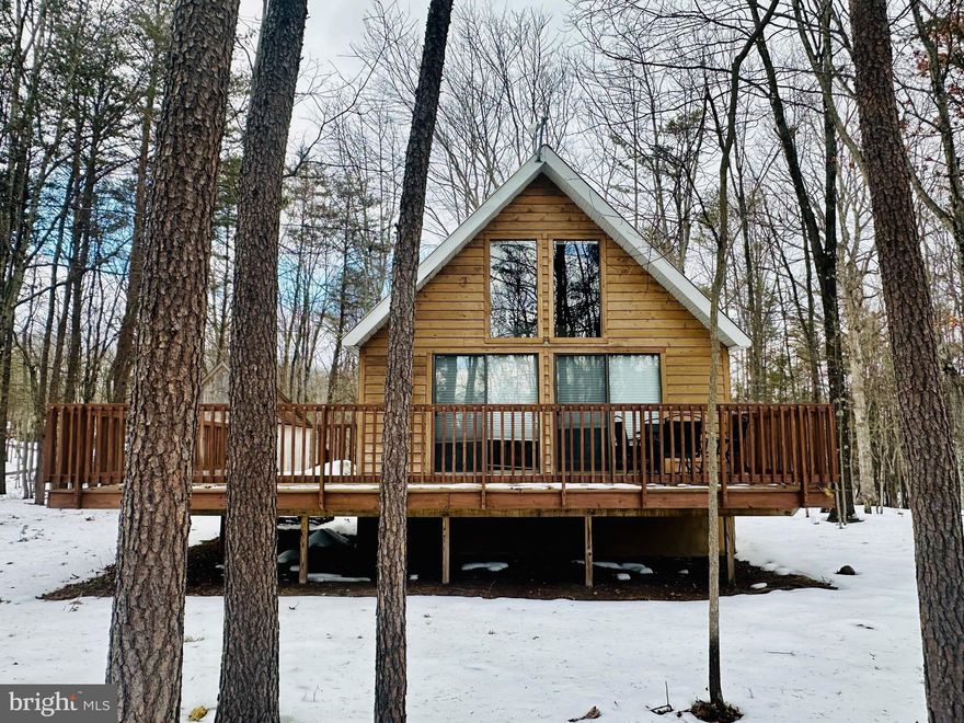 Storybook A-Frame Retreat with Acreage, Privacy & Modern Comforts! 

Welcome to your dream escape! This classic A-frame cabin blends timeless charm with everyday convenience, offering 860 square feet of warm, inviting living space nestled on beautiful acreage at the end of a quiet cul-de-sac. The cabin comes fully furnished and can also be considered as a great investment opportunity for Airbnb!

From the moment you arrive, you’ll fall in love with the striking architectural lines and welcoming wrap-around porch — the perfect place to sip your morning coffee, unwind with a good book, or gather with friends while enjoying peaceful views of nature. Evenings are made for the dedicated bonfire pit area, where stories, laughter, and stargazing come naturally. 

Step inside and you’re greeted by gorgeous wood floors throughout the main level, creating a warm and cohesive living space. The layout includes two comfortable bedrooms and one full bathroom, offering flexibility for guests, a home office, or weekend getaways. Spend time in the living area staying warm by the woodstove.  

The cozy loft bedroom is a true retreat, complete with soft carpeting and charming windows that let in abundant natural sunshine — an ideal spot to wake up with the trees just outside your view. 

This cabin is designed for comfort year-round with central heat and air, plus a durable metal roof that adds both style and long-term peace of mind. 

And here’s the best of both worlds: you’ll enjoy private, quiet surroundings with generous acreage — yet still stay fully connected thanks to fiber optic internet. Whether you're working remotely or streaming your favorite shows, you won’t miss a beat. 

This cheerful woodland retreat offers the serenity you crave with the comforts you need. Whether you’re looking for a full-time residence, weekend getaway, or investment opportunity, this charming A-frame is ready to welcome you home.