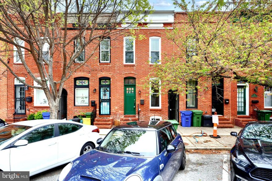Updated, light and bright row home in the heart of Canton! Clean, contemporary finishes throughout the house, with beautiful hardwood floors, and exposed brick walls. The first floor boasts a white gourmet kitchen, open concept living room and 1/2 bath. The second floor features two bedrooms, each with their own full en suite bathroom. The basement is also renovated with a full bathroom, perfect for an entertaining/movie room! Ideal for outdoor entertaining, this house has a private, fenced patio off the kitchen that is raised  8 feet above the alley for additional privacy, as well as an inviting rooftop deck! Being steps from Canton Square, the waterfront, and more, the location can't be beat.