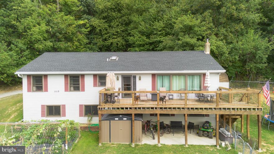 Escape to Peace & Quiet - Comfort and convenience is yours in this spacious rancher-style home set on 4.79 acres backing to State Park Lands, great to hike or hunt.   Custom built in 1985 with open floor plan, great room has cathedral ceilings, oak kitchen with all appliances & walk-in pantry.  Durable wood floors throughout main level, new roof 2022, and all new high-quality Andersen windows.   Master bedroom with master bath & walk-in closet.   Finished walk-out basement features large family room, bonus room, laundry room, 4th bedroom & 3rd full bath.    The hobbyist will appreciate the workshop area with storage galore.   New full-length custom deck in 2023 with large concrete patio underneath, perfect for soaking up the views, relaxing or entertaining and watching sunsets.     Four-year old barn with electric, berry bushes, and plenty room for gardening.    Deer, turkey and wildlife abound, a hunter's delight.   I-70 is a five-minute drive, ideal for commuters.    Located in desirable Smithsburg School District, this home combines modern comfort in a serene setting.   Country living is the best!