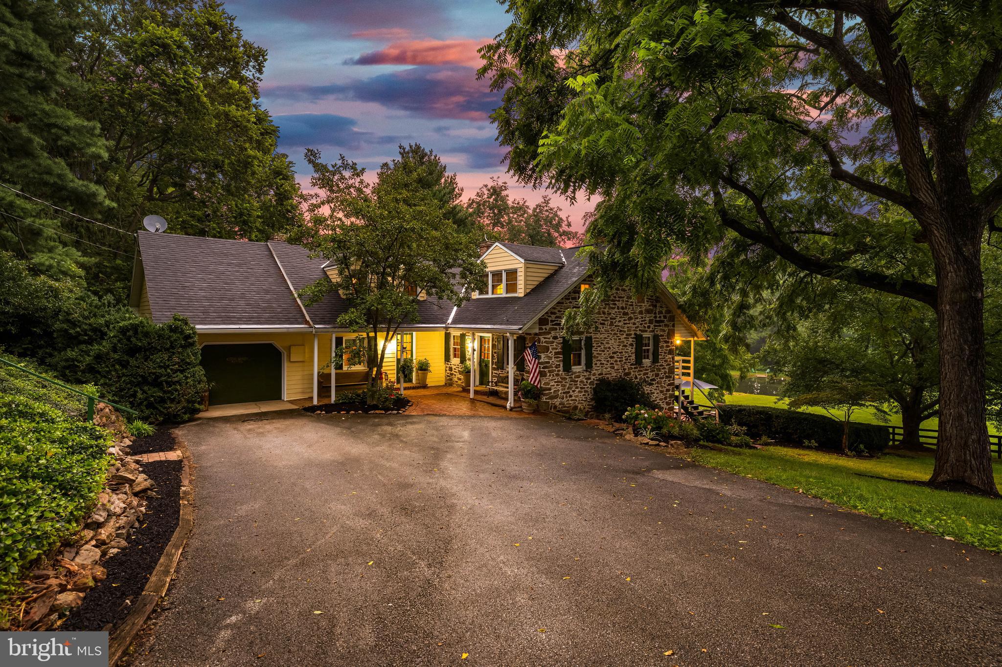 Welcome home to The Little Green Farm. This Farm consists of approx 31.5 acres, consisting of three separate parcels- potential to subdivide and bring the family. The home circa 1850, is a stone Cape Cod style residence offering over 3,300 sqft of living space. The property boasts peace and privacy at the end of a 1/4 mile tree-lined driveway- leading to the house, which includes hardwood floors, exposed beams, multiple bold stone fireplaces, and more. The kitchen has granite counters, a large L shaped island, stainless steel appliances, and access to a rear deck- perfect for coffee or a drink overlooking the pond and lower pasture. A formal dining room, den, and family room are located on the main level, along with a galley-style laundry and mud room. The lower level includes a living area/den, a bedroom, a full bath, and access to a gorgeous brick patio and the property’s springhouse. The springhouse is currently wired for electric and includes a bar area! Other outbuildings include a bank barn with three horse stalls and two pony stalls, a detached oversized garage with a workshop, and a tack/supply building. The land has fenced pasture, tillable (and fence-able) acreage under Clean and Green tax designation, Outdoor Riding Arena, and a pond. Upgrades include a new furnace (2024) and has central air conditioning. It offers a great potential for equestrian activities, and/or as a large private multi-family residence. A little over 10 miles from the MD/PA line, this is convenient yet secluded! Schedule your private tour today!