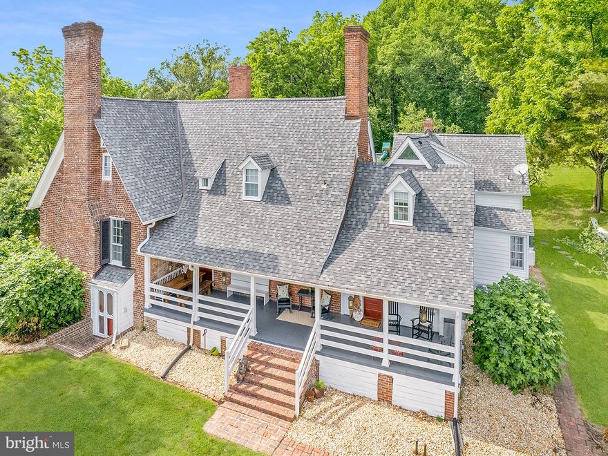 **PLEASE - No drive-bys, no driveway pull-ins, approved appointments ONLY.***  Multiple streams of passive income on Historic Cedar Hill Farm, none of which interfere with the quiet enjoyment of the main home and grounds. **Natural farm.  No pesticides or herbicides since 2017!  The Manor home offers over 3500 sf in the owners quarters with 4 bedrooms and 3.5 bathrooms.  Attached to the back of the main home, there is a full private guest suite with separate entrance and double balcony offering another 700+ sf with one bedroom and two bathrooms.  The manor home is over 300 years old and boasts stunning original brickwork, highly prized historic woodwork throughout, original wide plank flooring and huge open spaces with grand architectural features. Other residential dwellings include a large one bedroom guest house with stunning industrial farmhouse finishings and an adorable little one bedroom cottage with a private driveway. (Total of 3 homes plus the attached guest house)   The grounds include ancient shade trees (Chestnut, Elm, Oak, Maple and so many more), a stunning boxwood lined rose garden, rolling hills, pasture, gardens, and miles of wooded trails.  Buildings include: 60x120 indoor riding arena, 6 stall horse stable with a half bathroom, hot/cold water, large storage room, tack room, huge loft, large run-in for extra horses or livestock, two large tobacco barns, historic corn crib, tool shed, garden shed, cedar shake carriage barn, and multiple smaller storage buildings and livestock shelters. The rolling grounds also host multiple creeks/streams with small waterfalls and 2 wooden bridges. A stocked pond is ready for your fishing outings or small kayak adventures.  New features include approximately 20 acres of 2”x4” no-climb livestock/equine fencing with an extra electric line along the top (all of this fencing new in 2022.) Extensive cross fencing completed in early spring of 2023 to allow for easier pasture rotation. The master bathroom was completely renovated in 2021 as well as the main level powder room. New architectural roof in 2018. New steam boiler in 2017. 2 new HVAC systems in 2022. All carpentry restoration and all white wood surfaces scraped and painted on the main house in 2021.  The white cottage was scraped and painted inside and out in 2020.  Main house was upgraded with new insulation and the partial crawl space was encapsulated in 2020. With all of the restoration and renovations complete, this Historic gem is ready for you to move in and enjoy! (Agent owned)(Historic Preservation & Agricultural Preservation) History:  This land was originally settled by John Bigger and the property was known as Bigger Plantation.  The manor home was completed in approximately 1714.  By the early 1800’s, the property had changed hands and was owned by the Gantt family whose descendants still live in the area today.  The original property included over 1200 acres all the way down to the banks of the river.  Today, this brick home sits atop the highest point of the remaining 74+ acres.