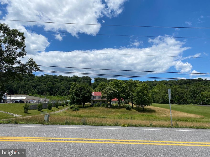7.71 ACRES situated along busy State Rt. 522   Explore the possibilities of building you home here.    Public water and sewer available.  Home is considered no value.   This would make a good spot for horses,  cows, chickens!   You decide!