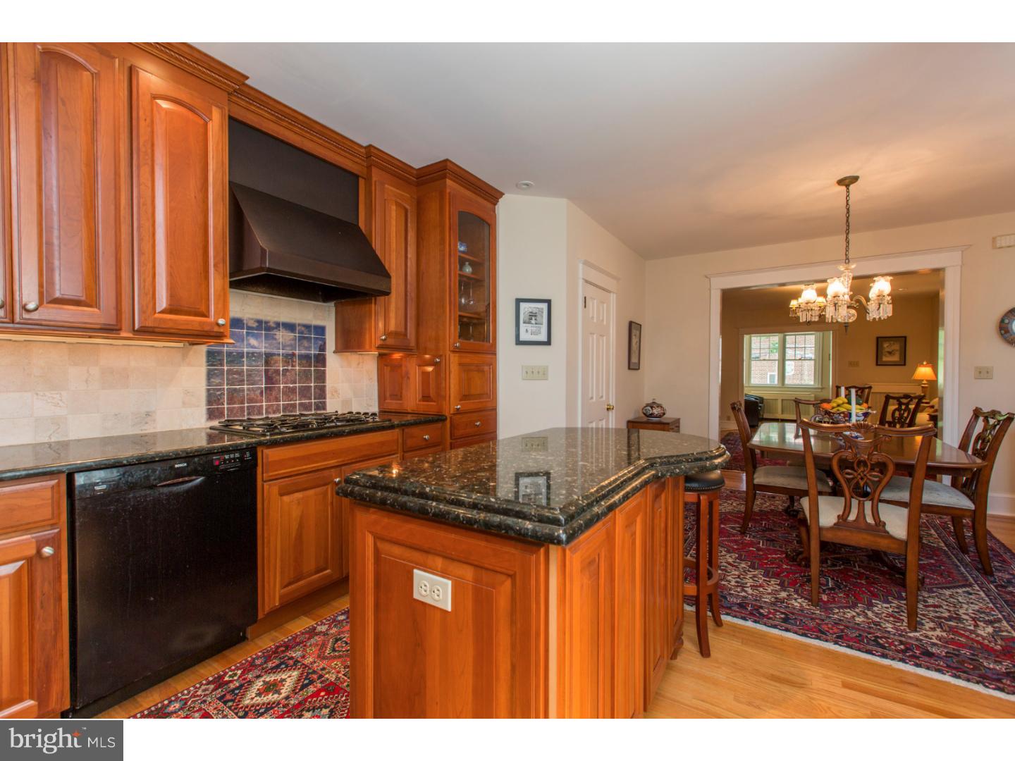 Move right into this beautiful two bedroom, two bath Chestnut Hill row home ideally situated on a quiet street in a coveted top of the Hill location. Completely and tastefully renovated with designs by acclaimed local architect, Krieger and Associates, the first floor features an open floor plan with a cook's kitchen and stunning custom cherry cabinetry, equipped with upper-end stainless steel appliances including a Bosch dishwasher, new refrigerator, Vent-a-hood exhaust fan, center island, and granite counters with custom made tile back splash. The kitchen opens right into the spacious dining room -- perfect for cooking and entertaining family and friends. A large living room, charming sun porch and small office with built in cherry cabinets and desk, complete the first floor. Upstairs, the wonderful master bedroom suite features an updated bathroom and spacious walk-in closet. Also, you will find an additional sunny bedroom and a full hallway bath. As an added surprise, there is a 650 bottle, temperature controlled wine cellar in the full basement! New roof, central air and gorgeous refinished ribboned hardwood floors throughout. Attached one car garage with off-street parking and a charming front courtyard patio complete the picture of this lovely home. A very short walk to everything -- shops, restaurants, 2 local trains and the Wissahickon park trails. This beautifully renovated home in an exceptional Chestnut Hill location is not to be missed!