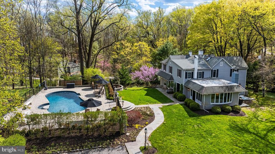Set amidst a beautifully landscaped 1 acre lot in the heart of Ruxton, totally renovated and expanded, flooded with natural light from its many windows, bay windows and French doors. The cozy farmhouse blended with a cool current vibe, perfect for today's modern living. The welcoming Foyer with classic staircase leads to a stunning sunken Living Room with fireplace, large windows, French doors and custom illuminated built-ins. Also from the Foyer is the formal Dining Room with fireplace, French doors and custom built-in china cabinets. The modern updated Kitchen features stainless steel appliances, soapstone and marble counters and a sunny breakfast area. An adjoining Family Room awaits with a gas fireplace, bar and 3 walls of windows including French doors to the patio. Also adjacent the Kitchen is a cozy Den with a fireplace and Powder Room. The upper level with mostly vaulted spaces has 4 Bedrooms, 3/1 Baths and laundry. The sumptuous Primary Suite features double sliding barn doors opening to a luxe marble Bath with a relaxing soaking tub, matching vanities and glass-enclosed shower. An en-suite Bedroom and 2 additional Bedrooms with shared Bath complete this level. The heated saltwater pool and pool decking/patios was renovated in 2022 and is enclosed with a decorative black metal fence.