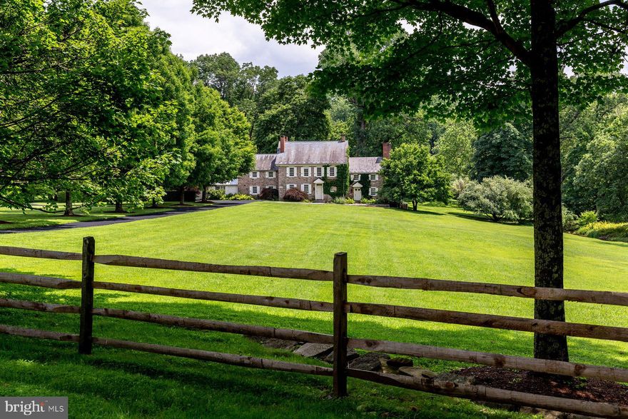 One of the finest estate properties in Bucks County, Finale Farm is a noble retreat deeply rooted in the heritage of the area with an original structure dating to 1704. On 33 acres in a pristine Solebury Township setting, the manor house is set far off the road with magnificent repose. The house has been carefully expanded several times and now measures 6323 square feet. Ancillary structures include an updated guest house, classic stone bank barn, pool, pond and access to a 20-acre private lake that's fun for canoeing, kayaking or even paddleboating. Level acreage makes this ideal for the gentleman farmer or buyer seeking verdant, long-distance views. The main residence's interior showcases substantial historical details such as an early walk-in fireplace and stone sink, exposed stone and beamed ceilings with modern amenities, including a clean-lined, European kitchen and baths, all by Boffi, and updated mechanicals and systems. Interiors are spacious and open with French oak hardwood floors throughout all levels and the guest house. Private quarters upstairs are comfortably sized with five bedrooms and four baths. There is a wealth of flexible space and guest or au pair accommodations with the main house. On the first floor, a gallery-style hall overlooks a large patio, an in-ground pool and gardens and leads to a fitness area and a big family room with a screened porch. Two guest bedrooms and a full bath are located on the upper level of this section of the house. For the buyer seeking a country property reminiscent of a spot in the English countryside, Finale Farm is a lovely substitute in an unparalleled New Hope location. Throw your Wellies and field coat in the car and schedule a tour to experience its serenity for yourself.