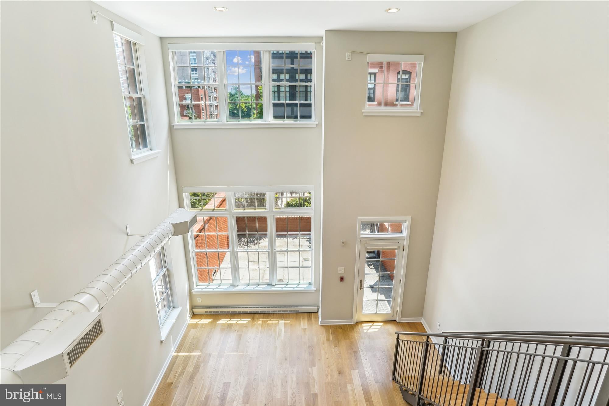 Rarely Available 2 Story End-Unit at Gaslight Square offers modern comfort & luxury! Private Entry off Large Main Level Patio! Living Room w/Wall of Windows & 21 ft high Vaulted Ceiling. Open Gourmet Kitchen with over-sized island/breakfast bar, Wolf Stove & Subzero Refrigerator. Private Patio Off Primary Bedroom! Refinished Hardwood Floors and Fresh Paint. 2BR/2.5BA +Loft w/parking accessed through main level. Conveniently located between Rosslyn and Courthouse Metros and minutes to DC!