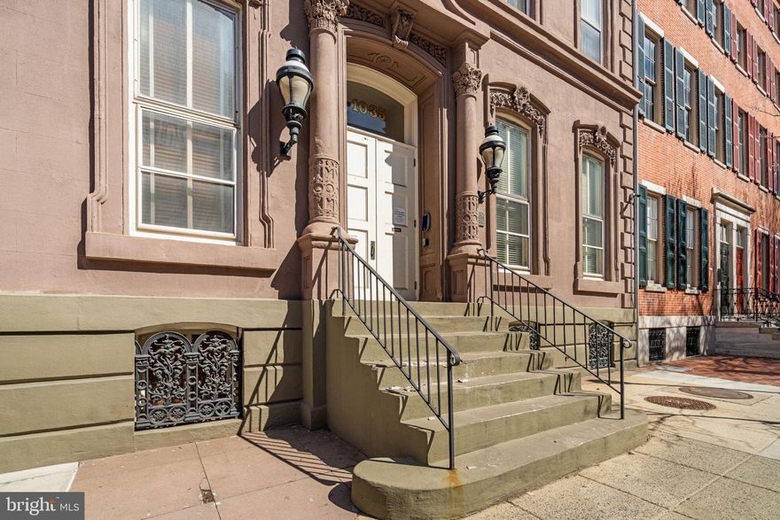 Located in Washington Square West, this one-bedroom corner unit at the historic Roberts-Quay House offers nearly 1,000 square feet of thoughtfully designed space filled with beautiful natural light and unique character not found in newer constructions.

The building reflects its rich history through striking architectural details while providing the comfort of modern updates. The southern and western exposures allow sunlight to fill the home throughout the day, accentuating the hardwood floors and creating a warm, inviting atmosphere.

The layout features distinct yet connected living and dining areas, along with a lofted bedroom that adds architectural interest and an open feel. A decorative fireplace serves as a focal point in the living area, which boasts 12-foot ceilings. The kitchen is equipped with stainless steel appliances, quartzite countertops, high-end finishes, an induction range, and a convenient breakfast bar for everyday dining or entertaining, along with a side hutch for additional storage.

The lofted bedroom includes a large closet, an ensuite bathroom with a double vanity, built-in additional storage, and a brand-new full-sized Samsung washer and dryer.

Additional features of the unit include central air conditioning with a brand new heat pump system, secure keyless building entry, an intercom system, and access to a bike room. The corner positioning of the unit enhances both privacy and natural light, ensuring the space remains bright and comfortable year-round.

This location places you in the heart of it all, with neighborhood coffee shops, local dining, and everyday conveniences just steps away. Public transit is easily accessible, and Jefferson and Pennsylvania hospitals are nearby, making this home particularly convenient for medical professionals or anyone seeking a vibrant city lifestyle.

This is a unique opportunity to own a home that perfectly balances historic character, modern function, and an unbeatable location in Philadelphia.
