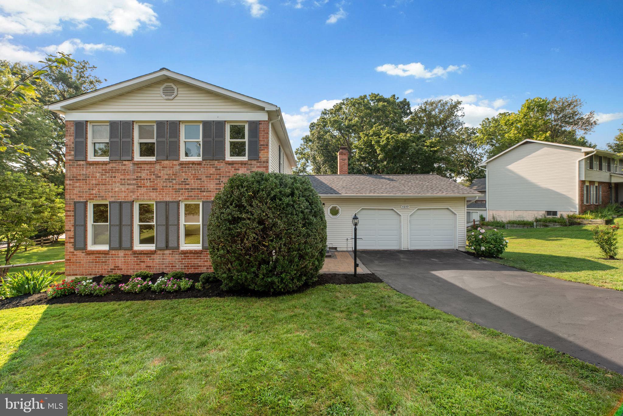 Charming Colonial residence offering 2,792 square feet, 4 bedrooms, 3.5 bathrooms (updated in 2025), and a 2-car garage—all set on a picturesque lot in desirable Meadowbrook. Lush, manicured landscaping and classic curb appeal welcome you into the traditional main level, where rich hardwood floors flow throughout the foyer, formal living room, sun-filled dining room, eat-in kitchen, and family room. The family room features a cozy wood stove with a brick surround and opens directly to an expansive, carpeted four-season sunroom with soaring ceilings, panoramic windows, and access to the backyard—perfect for enjoying the outdoors in comfort. The updated eat-in kitchen is both functional and stylish, showcasing sleek Silestone® countertops, warm cabinetry, black appliances, and a pantry. The open-concept design flows seamlessly into the family room, creating a connected space ideal for everyday living and entertaining. A main-level laundry room and a convenient powder room complete this level. Upstairs, you’ll find four bedrooms and two full bathrooms, including a spacious primary suite with a private en suite bath. The fully finished walkout lower level adds incredible versatility, offering a large recreation room, a full bathroom with a jetted tub, and a flexible bonus room. Enjoy peaceful outdoor living from the elevated deck, which steps down to a covered patio—both overlooking the large fenced backyard on a sought-after, beautiful corner lot. The flat, expansive yard is perfect for sports, play, relaxing, and entertaining, with mature trees providing natural shade and added privacy.