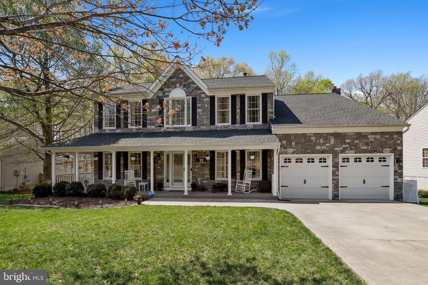 Beautiful and meticulously maintained 5 bedroom, 4 bathroom stone-front colonial in highly sought after Cardinal Forest community of Fredericksburg. Approaching the house, you will observe the quiet cul-de-sac street, oversized driveway and full wrap-around porch, creating excellent curb appeal. Upon entry, notice the 9 ft ceilings, open foyer, and living room, creating a bright and inviting atmosphere, as well as a bonus room, perfect for a home office. Inside, the kitchen boasts recessed lighting, stainless steel appliances, and a large center island, perfect for entertaining, leading directly to the separate dining room & breakfast nook. From the family room you can step into the sun room leading out to the back deck, perfect for relaxing in the morning. Traveling upstairs you will find the conveniently located laundry room, 4 bedrooms, including the primary suite, featuring a custom-built California walk-in closet, and a SECOND private sun room! The primary suite bathroom features a dual-sink vanity, walk-in shower, and a large jetted soaking tub. Three additional great sized bedrooms and a renovated main bathroom finish off the upper level. The finished basement features a full kitchen, bar with a wine fridge, gaming area, theater area, and plenty of additional space for entertaining. You will also find a 5th bedroom (not to code) and full bathroom off the kitchen, perfect for an in-law suite. Backyard boasts a 500+ SqFt deck overlooking the fully fenced rear yard, large garden area already blooming with veggies to last all summer, including some perennials that will come back up next year! Below the deck is an additional covered patio, for additional entertaining space. The home features a Front and Back-Yard irrigation system for effortless watering. The large garage boasts custom built-in shelving, creating plenty of additional storage space. New HVAC 2022. Come tour!