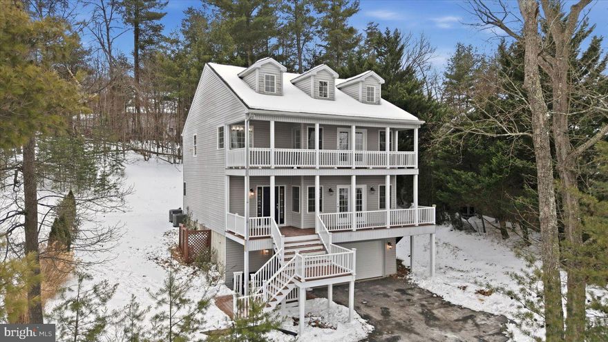 Spectacular Lake Home with Multiple Decks & Panoramic Views! Enjoy breathtaking wide-body lake views from all three levels of this stunning lake home in gated Lake Holiday! This coastal inspired contemporary features two expansive front decks including the primary suite private decks- where every sunset feels like a getaway. Designed for both entertaining and everyday comfort, the open floor plan showcases soaring circular tray ceilings in kitchen, elegant columns, and rich Brazilian cherry hardwood floors throughout the main level. The gourmet kitchen is beautifully appointed with newer stainless steel appliances, double ovens, a gas range, and generous prep space — ideal for hosting gatherings while enjoying the water views. Boasting over 3,200 finished square feet, this home offers exceptional flexibility. The fully finished lower level includes a third full bath and spacious flex area perfect for a media room, TV lounge, guest retreat, recreation space, or home office. Upstairs, brand new carpet enhances the upper level. The oversized primary suite features vaulted ceilings, double doors, large walk in closet, and access to an expansive private deck overlooking the lake — creating a true retreat experience. Bedrooms two and three are connected by a convenient Jack and Jill bath, offering both comfort and functionality. Multiple outdoor living spaces, generous interior layout, and incredible scenery make this property ideal for full-time living or the perfect lake getaway. Recent updates include: updated decking, whole house freshly painted, brand new upper-level carpet, newer HVACS, updated lighting, and newer kitchen appliances and washer and dryer. Beyond your doorstep, the Lake Holiday community offers an unparalleled lifestyle. Residents enjoy access to a magnificent 240-acre lake, ideal for boating, water sports, kayaking, canoeing, paddleboarding, swimming, and fishing. Also offering multiple sandy beaches, a large clubhouse with fitness center, various sports courts, hiking trails, dog park, and a marina with boat slips. Experience the perfect blend of modern comfort and resort-style living in this fantastic Lake Holiday home in a 24/7 gated community! Don’t miss the floor plan uploaded to photos.