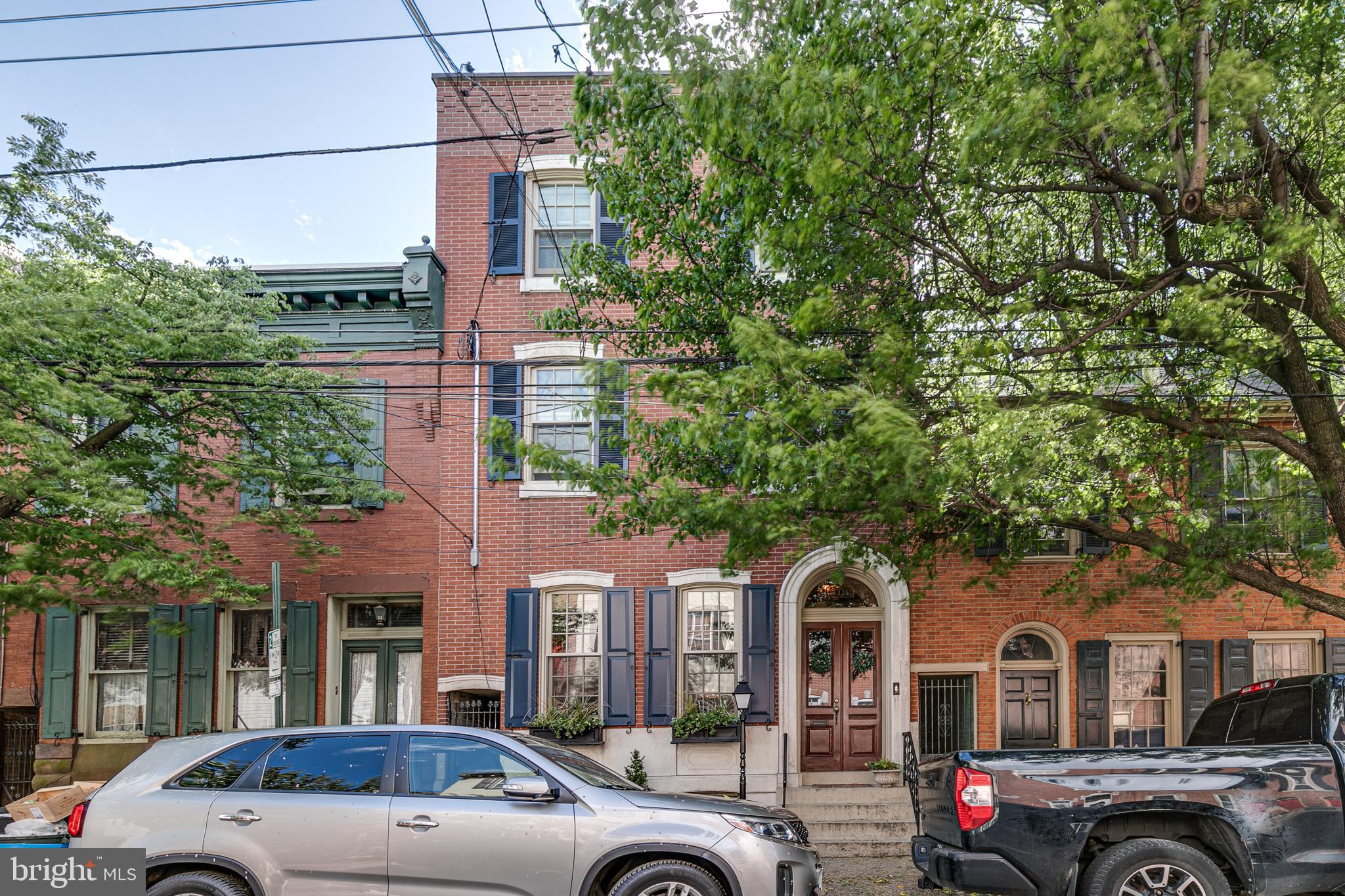 Welcome to this one-of-a-kind Fishtown masterpiece that compares to homes in the Rittenhouse House section and Delancey Streets of Philadelphia. Prepare to be wowed with this 20' by 102' lot featuring professionally up-to-date and modern touches combined with old-world character, charm, and awe-inspiring homes from the late 1800s.  Dedicated parking space located at 1029 Marlborough Street Space #2.  The exterior is breathtaking and includes a limestone external façade with a double-door entrance.  The vestibule opens up to an open concept first-floor living and dining room with curved original archways, original marble fireplace mantel  (nonfunctioning), old-growth pine floors, and dramatic 11' ceilings. This stylish home was fully renovated by a builder for his family so every detail went unmissed. The kitchen features Mouser Cabinetry with inlay setting, custom tin decorative ceiling, GE appliances including a 48 bottle wine fridge as the kitchen entrance focal point. Exposed brick walls highlight an urban feel throughout the house and perfectly compliments the custom millwork trim that matches exactly the original trim of the house. At the base of the butler staircase leading to the 2nd floor, you'll find the first-floor powder room and custom-built mudroom with storage, coat rack, and shoe storage. Leading out into the back yard there is a 10x20 patio which flows out into an additional 23x20 green space with a garden perfectly landscaped with perennials for furry friends and humankind alike. The 2nd floor features the laundry room, hall bath, and 3 bedrooms with dramatic high ceilings. The third floor features a hallway that leads to a Trex rooftop deck with unobstructed views of the city skyline and a serene master suite. The master suite features a tray ceiling with recessed mood lighting, a walk-in closet through to a master bath that includes a double vanity, makeup table, and walk-in shower. Dual-zone HVAC, each with its own designated air purifier, controls the 2nd and 3rd floors with a high-velocity system, and the first floor and basement with a conventional system.   Oh, the best part? The recently finished basement features a multi-functional room with custom built-in banquet seating with storage, plenty of “hidden” storage space throughout the long hallway that leads to a half bathroom, and a 538 bottle climate-controlled wine cellar featuring a refrigerator, floor to ceiling wine racks, stone façade that feels like you are somewhere in France, and locally sourced walnut and maple woods countertops from Haddonfield, NJ.   This home is located on the Riverside section of Fishtown on arguably the best block in the neighborhood. Everything is walkable, yet the street is quiet and quaint. Easy access to highways and the Market-Frankford line. This home is located in the Alexander Adaire public school catchment and includes one parking space a half-block away.