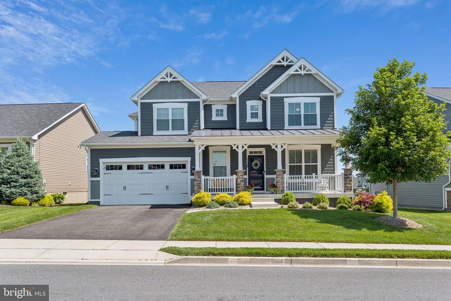 This stunning home has been meticulously maintained by the original owner who added all the major upgrades to their build and chose the finest materials and design features. The premium front elevation with welcoming front porch will delight you with its durable epoxy surface and views. The interior is fabulous and has a modern floor plan that you will love. There is a main level office with French glass paneled doors at the entrance and a gracious foyer opening up to an incredible open living area filled with natural light and featuring a gas fireplace with stone surround, top of the line hardwood floors, recessed lighting, crown moldings throughout, gourmet kitchen with large center island, gorgeous countertops, quality cabinetry, subway tile backsplash, all stainless appliance package including double wall oven, and walk-in pantry. The garage has an upgraded epoxy floor, extra storage space, and leads into a mud room perfectly designed to flow into the rest of the home.  The conservatory room is open to the kitchen and leads out to a terrific oasis of a fully fenced backyard that includes maintenance free decking, extensive hardscape with built in firepit and plenty of lawn space to run around. All around the home you will find a multitude of specimen plantings adding to the charm of this property. The shower in the primary bath has been recently upgraded with incredible tiles and glass door and has two vanities. There is a separate laundry room upstairs as well. The basement is amazing and features a full wet bar with wine fridge, quality cabinetry, and glass tile backsplash. The board and batten walls create an eye pleasing area to relax in. There is also an extra room with glass paneled French doors that can be used as a playroom, exercise room or office. Shows like a model home! All in coveted Tuscarora Creek.