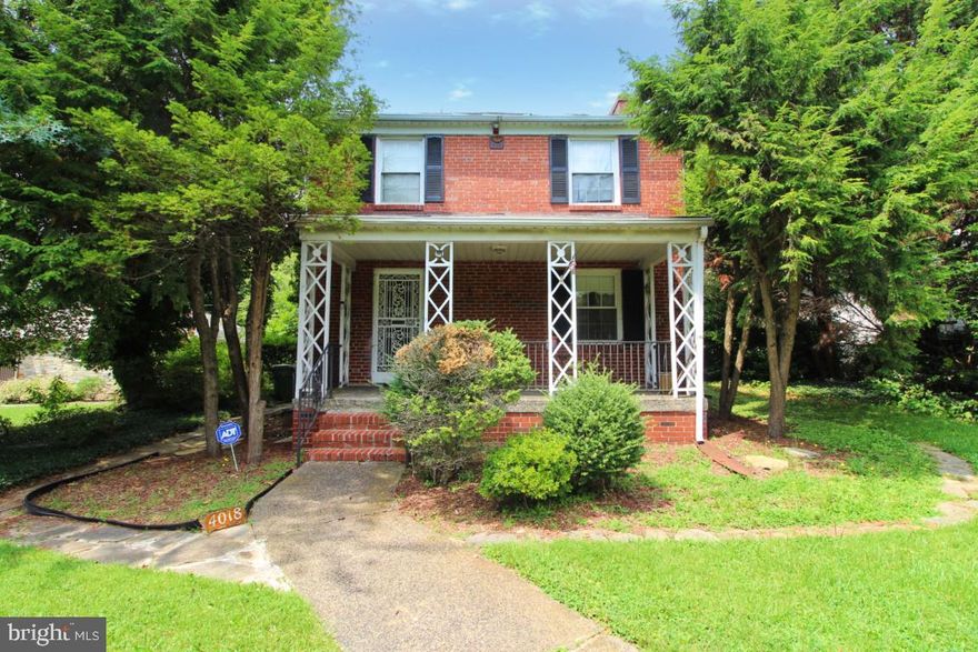 Price Improvement! Seller Very Motivated and willing to entertain all offer.  This Classic Brick Colonial Home sits on a large corner lot in the heart of Original Northwood Baltimore. Original Hardwood floors underneath carpet throughout ready to be brought back to life by you.  A fireplace in the family room ready for those fall/winter nights, located in the basement.  Home is surrounded by plenty of flat land and mature landscaping. Enjoy all four seasons on the front porch overlooking the spacious front yard.  Separate detached garage and private parking.  Come see your new home at a great price with plenty of potential to customize as you please! Seller very motivated and will contribute towards closing cost! Ask us how you can settle with no money down!