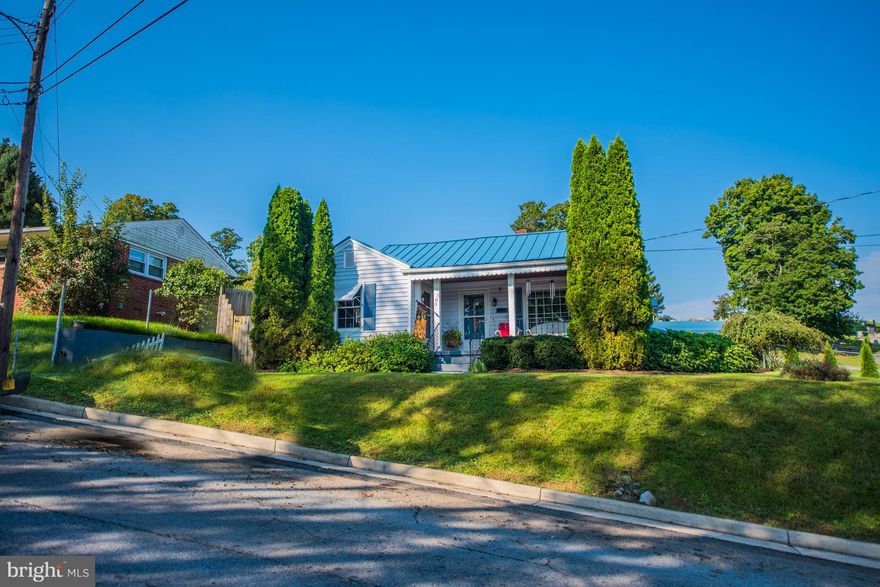 Just vision this charming home being yours! Sit on the front porch & enjoy your morning coffee. Enjoy the spacious rooms, hardwood floors, & charm this home has to offer. Home offers LR, DR, large country kitchen, 2 main level BR and 2 BR on upper, 2 full baths, vinyl siding, a new metal roof, large back yard, covered back porch, landscaping and much more! This is the home you've been waiting for!