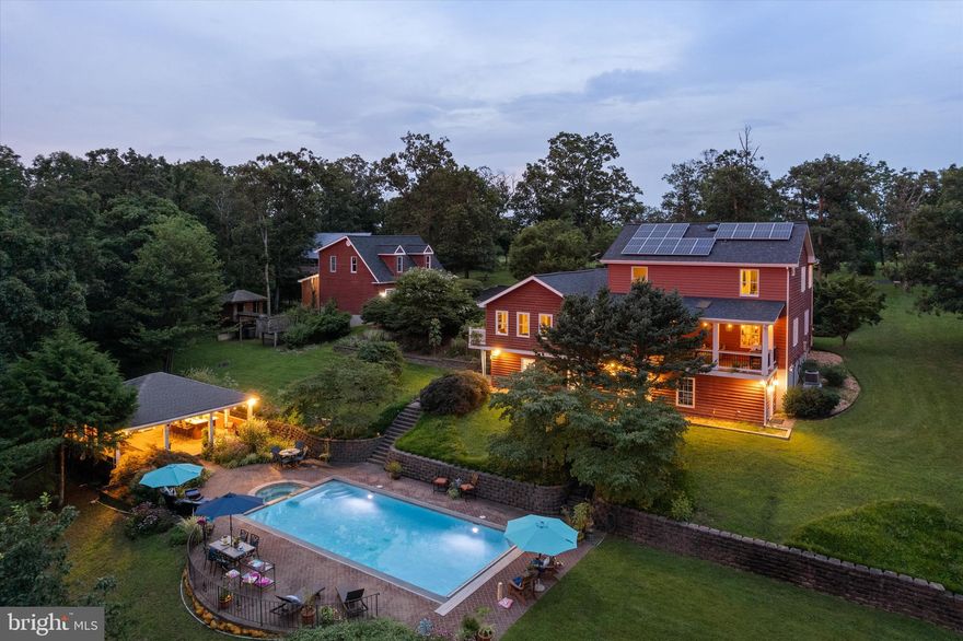 Fresh to market is this unexpected property that offers the sense of home combined with the amenities of a full-time retreat.  This country escape is located within minutes of town with NO HOA.  Markets, restaurants, stores, shopping are handy for a quick errand  and allows you to  get back  fast and enjoy a lazy day at the pool.  Additional offerings include 9.83 private acres, a fully outfitted in-law quarters, stunning Gunite pool/hot tub combo with pavilion, detached garage, barn and the most amazing sunsets.  Enjoy the good life roaming almost 10 acres of private property with lush forest for hunting & cleared areas for gardening with lots of room to play.   Inside are many & varied spaces to curl up and  read a good book, create, entertain and enjoy the Big Game with friends  and family.  The main home has 4 Bedrooms & 3.5 baths, and 3 finished levels.  Kitchen is large with  tons of counter space, cabinets & pantry and amazing views.   You have formal  dining and study as well as casual spaces; family room , 3 season porch and the Biggest, Brightest Playroom.  Summers are extended with your very own heated pool.   Host pool parties like a pro under the pavilion with gas grill hookup, fridge, serving bar and tons of table space.  The hot tub and outdoor shower are added luxuries for all to enjoy. Full finished basement is open and light filled with 5th bedroom, full bath, laundry room, family room , changing room  and with a pool table, this is the perfect place to hang out.   Detached garage offers parking,  work benches & an unfinished upstairs with rough-ins for kitchen and bath.   Find additional space on rear of garage for storage or a potting room.   Next, discover the Barn....charming & nostalgic and useful for the every level of farmer.  Yes, bring your chickens!  In-Law suite is on the main level of the home with private entrance, kitchen and bath.  It has it's own deck and thermostat!  Property is oufitted with 3 zones for HVAC.  24 Solar panels ease the cost of utilities. This property is a dream come true with space for every generation and endless things to do.   It's truly magical in that getting back to nature is so close to town. 

Current owners utilize Starlink for internet. 

Updates: Roof replaced in 2024 on house and detached garage. Family Room renovated 2019 to include addition of gas fireplace, built-in book cases, carpet, ceiling fan and plantation shutters. Rear covered porched beautifully updated in 2022 w/ new Trex Flooring, Re-boxed Columns and New Railings.   2020 Primary Bath remodeled featuring Step-in shower w/ glass doors, comfort height vanities & lighted vanity mirrors.  2017 Gunite pool was resurfaced and New pool pump and heater were added.  

*Camera's in use on property*