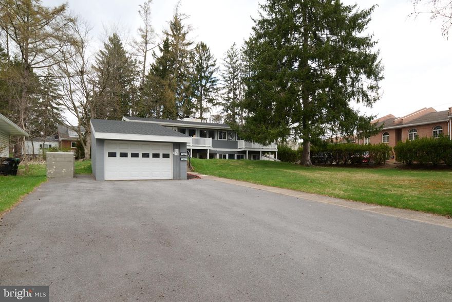 Nicely updated mid-century modern home in a desirable State College borough neighborhood. Inside you will find vaulted ceilings, a wall of windows, and bright, open living spaces with natural light.  Improvements include refinished oak flooring, fresh kitchen cabinets with some newer appliances, butcher block countertops, newer roof on home and garage and updated bathroom flooring.  Two fireplaces, perfect for colder evenings. The multiple decks provide ideal spots for morning coffee. Enjoy a finished lower level for additional living space with kitchen, family room and laundry. This unique home is for those seeking flexible living options. Other highlights include an oversized garage and close proximity to schools, parks, shopping, and downtown amenities. A wonderful opportunity.