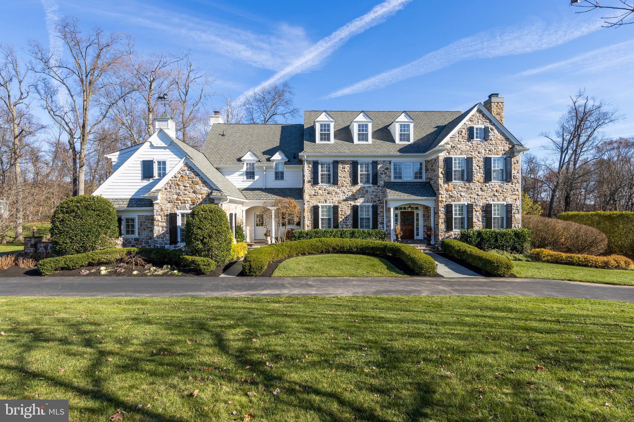 Stunning stone colonial in the coveted "White Horse" neighborhood. This beautiful manor home is the premium White Horse floor plan and is situated on one of the best lots in the community! A private setting on a quiet cul-de-sac, this home overlooks the wooded back and a private walking path to the Episcopal Academy campus. This home is truly special, offering a brand new modern kitchen remodel and over 7,000 sq ft with 4 levels of living space. Every detail has been attended to from the custom mill work, curved archways, 10ft ceilings, raised panel wainscoting, hardwood floors to the custom cabinetry and lighting. Enter the beautiful, classic foyer with a grand staircase, detailed moldings, and custom millwork throughout. The formal dining room and living room on either side as you step in. The living room, detailed in custom millwork, is light filled and has a gas fireplace. The formal dining room is the perfect size for hosting and entertaining with great flow to the kitchen and family room through the foyer or custom butler's pantry. Off the foyer is the private office with mahogany custom built-ins, and gas fireplace. The gorgeous formal powder room services the living room, office and dining room. They say the kitchen is the heart of the home, this stunning kitchen is will make your heart stop! Recently updated, the kitchen boasts custom cabinetry, a large island with seating, brand new beautiful Quartz countertops, top of the line appliances, and stunning lighting fixtures. Sneak upstairs via the rear staircase; full functionality for today's family. As the hub of the home, the kitchen is open to the family room, large breakfast room, mud room with built ins and second powder room. The family room is warm and inviting with custom wainscoting, wood burning fireplace with gas lighter to make starting a cinch, plantation shutters and hardwood floors. Windows abound the back of the home, looking out onto the private backyard, and French doors open to the large outdoor living space. Mature trees and landscaping with large firepit area complete the backyard. As you head up the main staircase, the raised panel wainscoting and hardwood floor leads you to the master suite. Enter the sitting room, with west facing windows, to be used to relax or for a second office. The master bedroom has a tray ceiling, windows, custom fitted his and her closets and luxurious master bath. The master bath includes his and her separate vanity/ sink areas, soaking tub, toilet closet, and large shower. In addition to the master, there are 4 large bedrooms with en-suite bathrooms, all on the 2nd floor. Second floor also includes separate laundry area and twin workstations, perfect for virtual learning! 3rd floor is finished and is perfect for a hang out room, exercise room, or another office. The walkout basement is also fully finished with a projection screen and surround sound for a theater-like experience, separate exercise room, full bathroom and area for ping-pong, games and more. 3-car garage is equipped with custom, built in organization system. In addition, you are close to Paoli and Newtown Square town centers, and much more. Don't miss this opportunity! Please note that Delaware County is conducting a real estate tax reassessment, effective January 1, 2021. If you have any questions or concerns, please contact the Delaware County Treasurer's Office or call the Tax Reassessment Hotline at 610-891-5695.