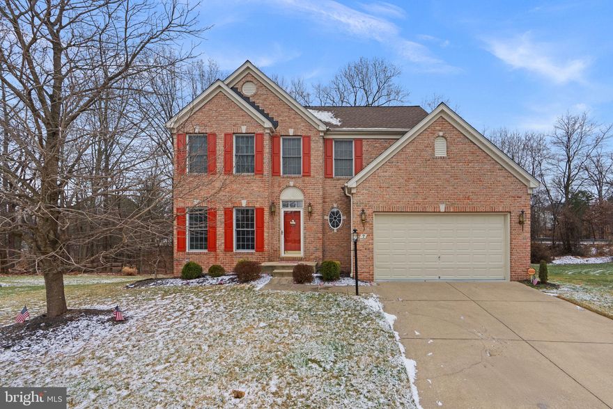Charming brick-front single-family Colonial residence showcasing 4 bedrooms, 2.5 bathrooms, 2,318 finished square feet, and a 2-car garage, ideally situated on a welcoming cul-de-sac in established Northwind Farms. The traditional floor plan begins in the foyer, which opens to a formal living room that flows seamlessly into the formal dining room. The dining space is defined by sophisticated columns and enhanced with elegant design details, including chair railing, a crescent window, and a chandelier. The inviting eat-in kitchen is well-appointed with an island, sleek black appliances, ample cabinetry, and a cozy breakfast area with access to the deck. Just off the kitchen are a convenient laundry room, a stylish powder room, and a spacious family room featuring a fireplace, ideal for everyday living and entertaining.

A staircase equipped with a chair lift leads to the upper level, which offers four bedrooms and two full bathrooms, including the primary suite with a tray ceiling and a private ensuite bath complete with a dual-sink vanity, soaking tub, separate shower, and a water closet. The lower level provides a finished recreation space perfect for entertaining or relaxing, along with an unfinished area ideal for storage or future customization. Enjoy dining al fresco on the deck overlooking a backyard that backs to trees, offering a peaceful outdoor setting.