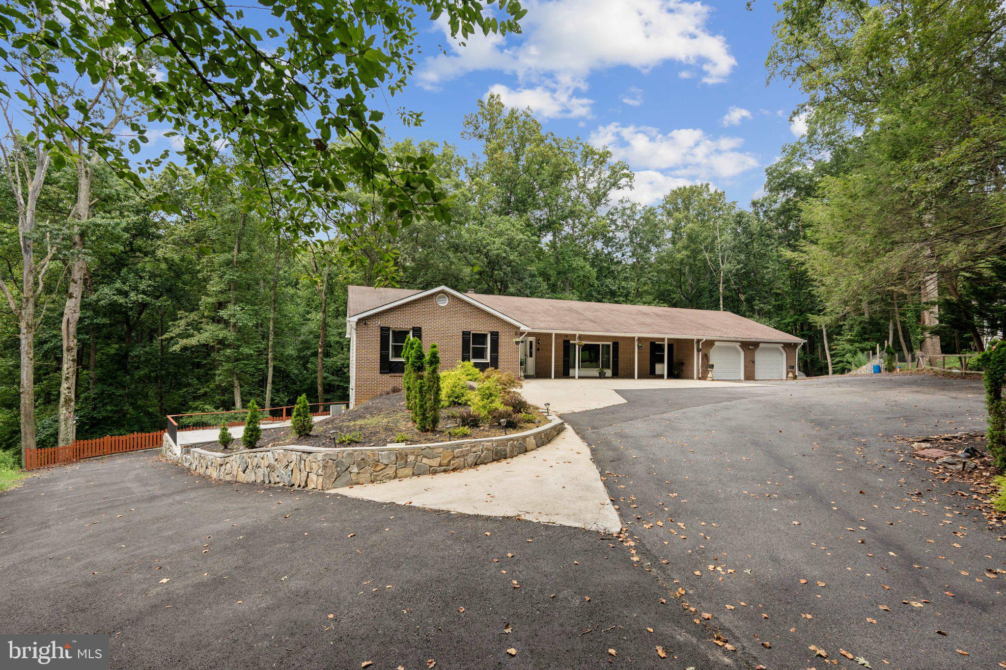 Tucked away on a quiet cul-de-sac in the Upper Seneca Crest neighborhood, this brick rambler is more than a home—it's a private estate. Spanning over 5,100 square feet on a generous 1.24-acre lot, this property offers a unique blend of spacious country living and suburban convenience.
The main level is an elegant canvas for everyday life and formal entertaining. A welcoming foyer leads to a sun-drenched living room with a cozy brick fireplace, while the formal dining room is perfectly situated for hosting memorable dinners and gatherings. The eat-in kitchen, with its granite countertops and double wall ovens, is a functional heart of the home, offering beautiful views of the beautiful lush, wooded backyard. The primary suite is a true sanctuary, featuring two walk-in closets and a private deck where you can enjoy your morning coffee, diving into your novel of choice or simply basking in the sun surrounded by nature. Three additional bedrooms and two full baths are uniquely situated on this level.
With unlimited use of space, the walkout lower level is a destination in itself. A huge living space, two additional rooms and two full baths, align perfect for comfort and entertainment.
Outside, the property provides a serene escape with its scenic, wooded lot and multiple outdoor spaces. Practical features abound, including an oversized two-car garage, a separate carport, grilling area and extensive parking. This home is move-in ready.
Quick access to the I-270, ICC-200, and the Metro, you can enjoy the best of both worlds. This is not just a house; it's a lifestyle waiting to be discovered.