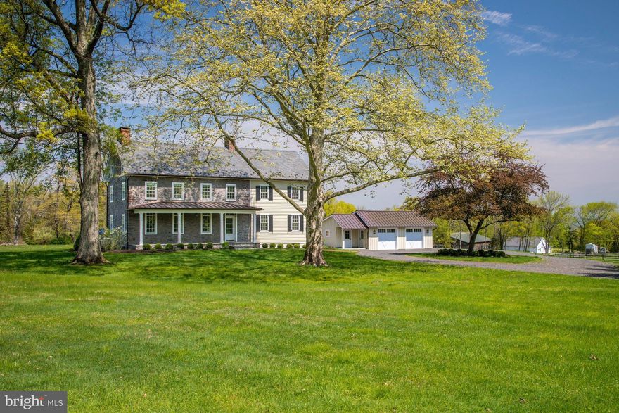 Set on an enchanting 98.68 acres, down a quarter mile drive through mature woodland, and nicely removed from a quiet country road in historic Bucks County, River Ridge Farm is a treasure. An historic red brick, one room school house is on the property, at entrance to the lane. Once known as the Guggenheim Estate, now beautifully transformed and embellished, this gentleman's farm is a quintessential representation of all that is unique to Pennsylvania architecture, in an exquisite and secluded setting, overlooking the Delaware River from high atop Chestnut Ridge Road. The circa 1823 pointed stone home was restored, with panache, in 2018. Only the best materials were used, including Azek trim, Hardi Plank siding, a 2018 slate roof with snowguards, and copper gutters and downspouts. A covered front porch beckons with bluestone flooring and a mahogany ceiling. Inside, wide plank floors span both levels of the home, enhancing the history and warmth. The large living room has two exposed stone walls, new, true-divided light Pella windows with deep window sills, and a wood-burning fireplace perfect for chilly evenings. Nearby, the den can serve as a first-floor bedroom, with its own gas-log fireplace. The floorplan flows naturally into the oversized kitchen boasting every modern convenience and top-of-the-line accoutrements.  Leathered granite countertops, with marble and grain bin backsplashes, merge seamlessly with abundant white cabinetry, a paneled Sub Zero refrigerator with separate freezer drawers, and a stainless steel Viking cooktop.  Adjacent, the original summer kitchen is now a dining room, featuring a cozy Jotul stove and opening to the wrap-around bluestone patio. Embellishing the patio is a timber frame pergola with led lights and a built-in Wolf grill with stone surround, and gas lamp lights that spring to light with the flick of a switch. The open and airy master suite will soothe and pamper. The bedroom keeps things simple and inviting, with 9' ceilings and plenty of windows. A private hallway opens to a walk-in closet with built-in organizers, while the master bath features marble countertops and a glass-walled, marble shower with rainfall showerhead. Rounding out the suite is a cozy room, suitable for an office or additional bedroom, with a fireplace, a hidden laundry closet and an additional sink. Two more bedrooms with large closets, and a hall bath complete the second floor, while a full attic offers room to expand. Downstairs, the lower level is heated, cooled and partially finished with a large exercise room and outside entrance to the bluestone patio and nearby garage. Multipurpose buildings are perfectly positioned amidst the acreage. A detached, heated, cooled and security-monitored garage has copper roofing, cypress ceilings, pine walls and easily accommodates 2-3 cars, with an attached ATV bay. The picture postcard, 1800s stone bank barn provides multiple purpose storage or a venue for conversion. For the horse enthusiast, the facilities include a large indoor riding arena, stable with 5 stalls, tack room and 2 run in stalls, an outdoor arena with grit footing and split rail pastures.  Miles of walking and riding trails lead one through the woods out to the tall cliffs overlooking the Delaware River. This intimate and rare setting in Upper Bucks County is a perfectly private oasis, yet still within easy driving distance to shopping, dining, and recreation. River Ridge Farm is an elegant estate from a bygone era, meticulously updated to embrace modern sophistication.
