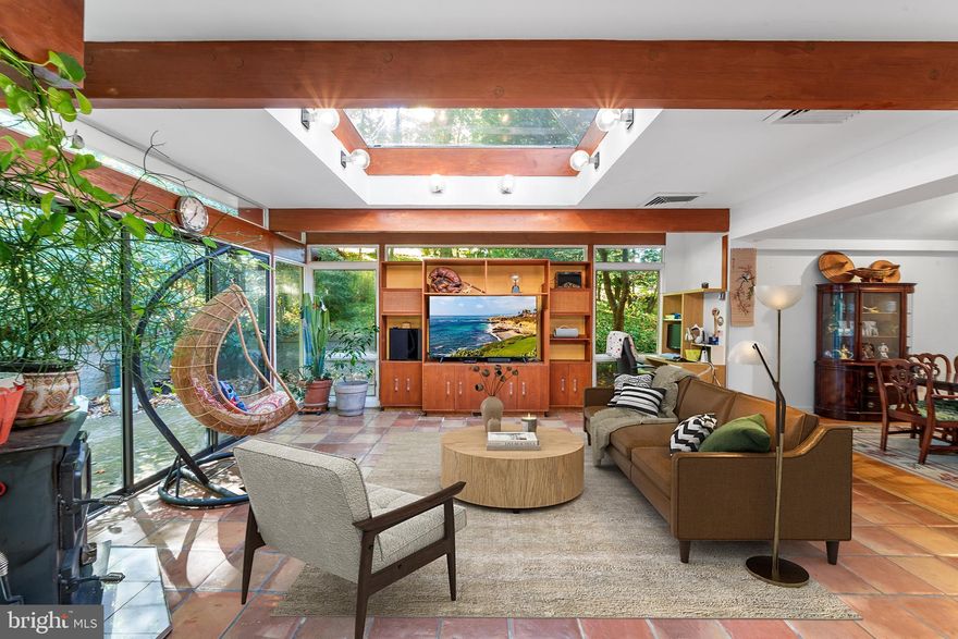 Welcome to this stunning, custom-built home in Old Wyncote, nestled on a private, expansive one acre
lot. Setting back away from the busy road insulated from the traffic noise, this beautifully designed
property boasts an open concept extension with skylights filling the space with natural light and offering
picturesque 180 degree view of the forest like slope. The spacious 12-foot ceiling living room features
parquet floors, a gas fireplace, and recessed lighting, flowing seamlessly into the formal dining room,
family room, eat-in area, and enormous kitchen. The family/great room is equipped with a wood-
burning stove, sliding glass doors to the patio, Terracotta tile floors, and a large skylight dome. The
oversized kitchen showcases ample granite counters, a center island cook-top, and plentiful cabinets,
along with a built-in wall microwave and oven.
The upper level consists of a master suite with a full bathroom, three additional bedrooms, and an
updated hall bath. The lower level has a large playroom with sliding glass doors and a laundry area. A
unique feature of this property is a separate, small apartment with a full bath and kitchenette, perfect
as a guest or Au-Pair suite. Outside, enjoy the beautiful brick patio with stone fire pit for outdoor
entertaining, surrounded by a park-like setting frequented by roaming wildlife. Additional benefits
include a recently replaced roof (2021), fresh internal/external paint, a two-car garage, partial basement
for storage, and an expansive driveway for additional parking. Conveniently located near main roads,
schools, parks, restaurants, and shopping, this rare find offers an incredible opportunity. Don’t miss out
– schedule your showing today!