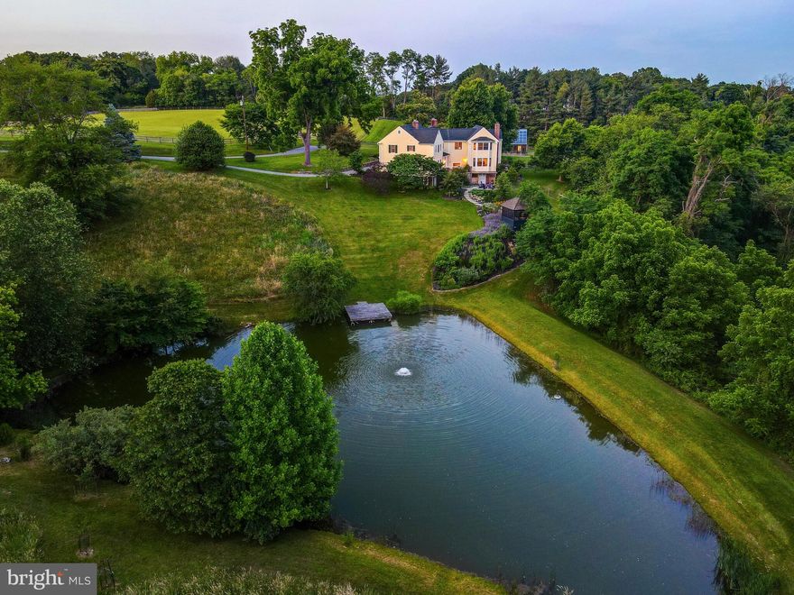 Sunnyfold farm, sited amongst the rolling hills of the Green Spring Valley since 1840, is one of the Valley’s greatest hidden gems. Located in the heart of preserved land, this storied estate boasts an 8-stall barn, gorgeous pond, and blooming greenhouse. Originally built from timber, the house has seen multiple additions most notably in the 1970’s and 2000’s. 
Mature perennial gardens and walking trails throughout the property offer majestic views of the verdant oasis. Flowering dogwoods, river birches, and persimmon trees speckle the hill overlooking a docked pond and screened-in pond house. The two fenced-in paddocks feature a run-in shed and automatic waterers ready for your equine and bovine pursuits. The gracious 4-bedroom farmhouse has multiple woodburning fireplaces throughout. A large eat-in kitchen offers spectacular views of the gardens and pond. Stone walls punctuate the landscaped entrance with beds of daffodils and zinnias.  A sense of tradition echoes throughout while modern amenities add to the quiet elegance of Sunnyfold. The primary suite, with vaulted ceilings and spa bath, was completely remodeled in 2023 and offers radiant heat floors and decadent finishes.
Original hardwood flooring and millwork blends harmoniously with the modern additions.  French drains, new HVAC, solar panels, and mechanicals make Sunnyfold farm both move-in ready and eco-friendly.  This is the ONE property in Green Spring Valley countryside that is truly a must-see.

Please see MLS uploads for an extensive list of updates and features.
Do not drive down driveway without appointment.