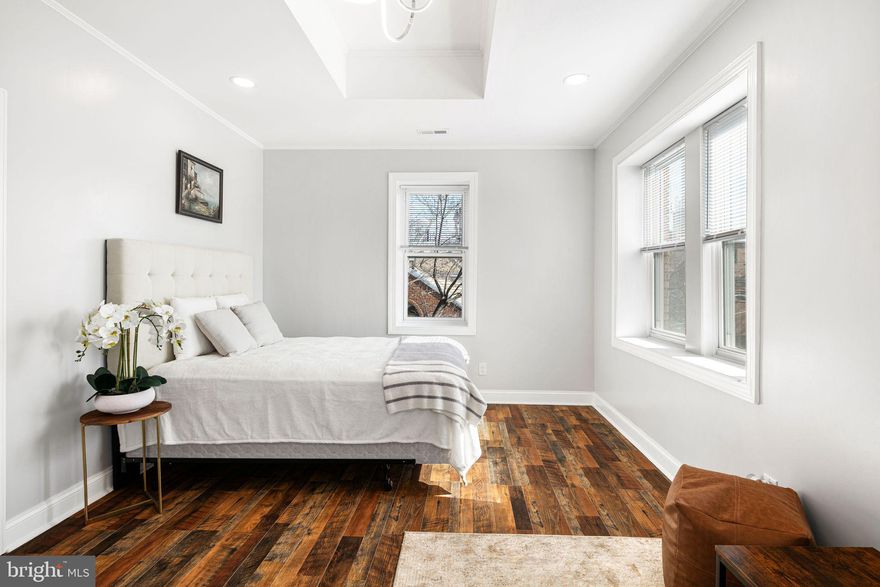 Discover 1035-37 Bainbridge Street Unit A, a rare versatile multi-family building in Philadelphia’s Bella Vista neighborhood bordering Washington Square West. This property easily offers the perfect blend of multi-generational living or rental income potential with modern city luxury! This adaptable property features two distinct living spaces plus an additional garage and lower-level den/entertainment space. It is an ideal opportunity for homeowners seeking flexibility, investors looking for an income-producing rental, or families wanting a separate private suite. Spanning multiple levels are 2 spaces that could be used as one home or individual units. The largest upper unit boasts 2 beds and 2 baths with a kitchen and dining areas! The spacious primary bedroom has an ensuite bathroom, skylight, and a seating area with dual closets with organization systems. The second bedroom has gorgeous floor-to-ceiling white built-ins, gets incredible light, and is directly across from a laundry closet equipped with a side-by-side new washer and dryer. The second full bathroom features a jacuzzi tub and shower, all fully updated. A cozy living room with a fireplace sets the perfect ambiance for relaxing nights. The fully updated kitchen has higher-end stainless steel appliances, white quartz countertops, and 2 tones maiden cabinetry. All spaces have access to a private deck that offers unobstructed, breathtaking city skyline views! The lower-level unit provides its own separate living space, complete with a Murphy bed, full bathroom, modern kitchen, and home office or flex space—ideal for extended family, long-term tenants, or Airbnb potential. Below the garage is a fully finished basement that adds even more possibilities, perfect for a home gym, movie theater, or den space, and has an additional full bathroom! Designed with style and functionality, this home has all-new interiors, so it's ready for move-in. Completing the home is a private garage with hand-painted floors, offering secure parking in the heart of the city.  A unique highlight of the property is its direct connection to Philadelphia’s famous Magic Gardens, with an original Isaiah Zagar mosaic art piece! With a Walk Score of 95, this location is a walker’s paradise, allowing daily errands to be accomplished on foot. Additionally, it boasts a perfect Transit Score of 100, indicating world-class public transportation options. With easy access to public transit, I-95, and major highways, this Bella Vista Beauty is a rare opportunity to own a versatile, property in one of Philly’s most sought-after neighborhoods.