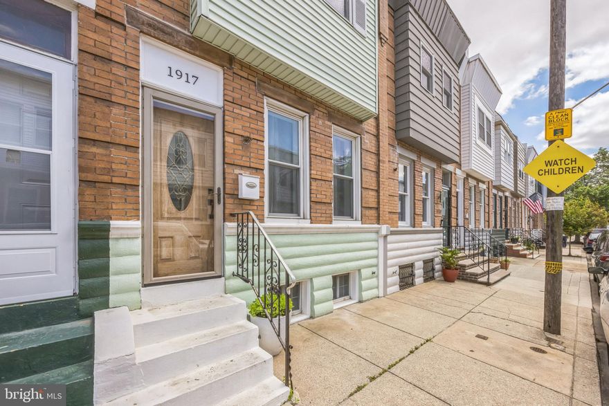 Welcome to 1917 S Galloway Street — a classic rowhome nestled in the heart of Pennsport, one of South Philadelphia’s most charming neighborhoods. Located on a wide, tree-lined street and just steps from local favorites like Gooey Looie’s and Rebel & Wolf Cafe, this home is also within walking distance to the beloved Dickinson Square Park and big box stores such as Target and ACME — the perfect setting for vibrant city living.
Step inside through the welcoming vestibule into a bright and airy living room filled with natural light and high ceilings. Hardwood floors run throughout the 1st floor, offering a seamless blend of modern updates and charm. The open layout living room flows into the dining area and updated kitchen, complete with stainless steel appliances and ample cabinet space.
Upstairs, you’ll find three comfortable bedrooms and a centrally located full bathroom with a tub. The primary bedroom features a large reach in cedar closet.The basement offers plenty of  storage space and houses the washer and dryer.
Outside, enjoy a backyard with modern privacy fencing — perfect for relaxing, gardening, or entertaining guests. Don’t miss your chance to call this beautifully maintained home in Pennsport your own!
