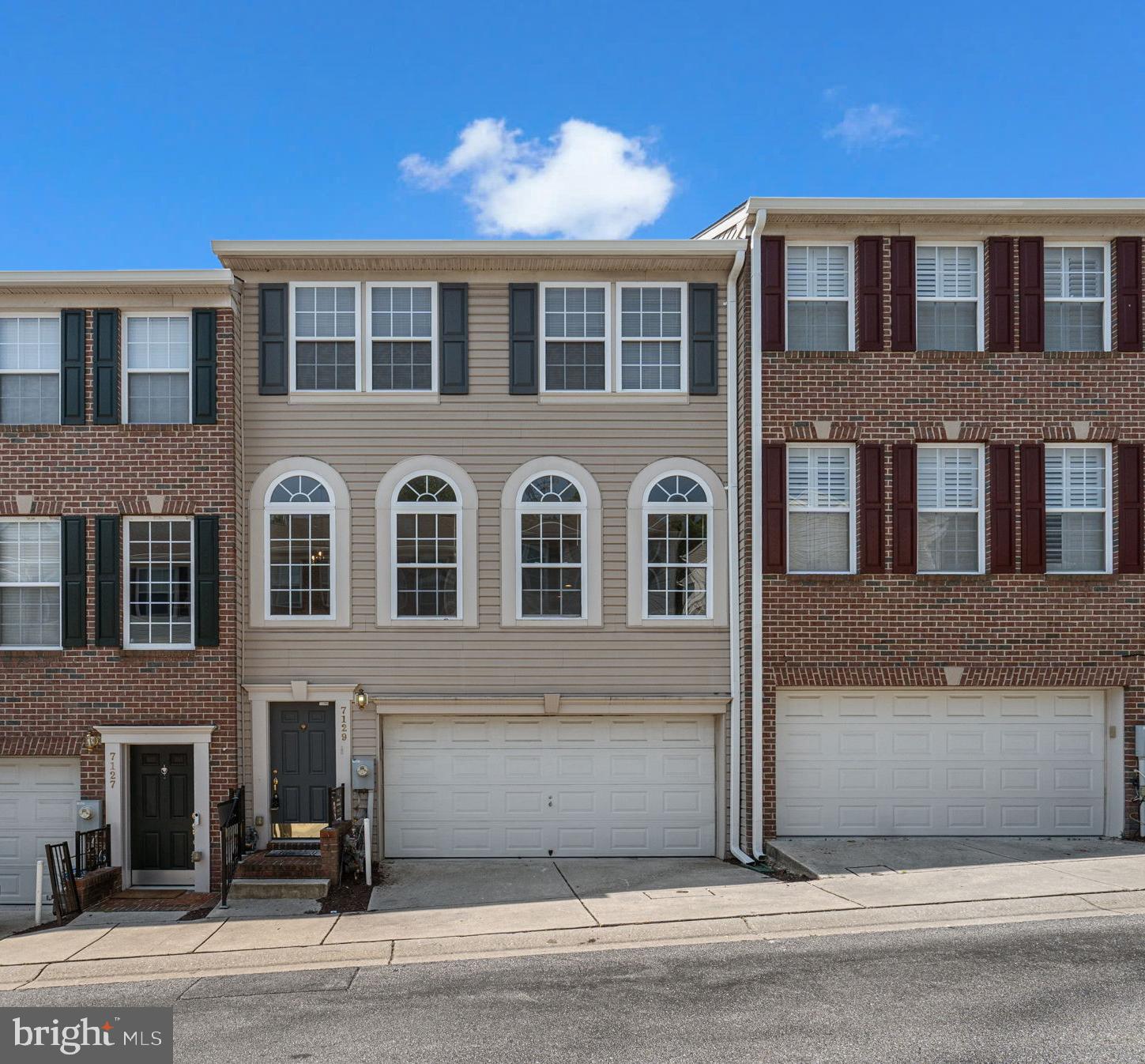 Beautiful townhouse residence offering 2,056 square feet, 3 bedrooms, 2 full baths, 1 half bath, and a spacious 2-car garage available for lease in desirable Waters Edge. Step inside the foyer and ascend to the main level, where a bright, open, and airy living room welcomes you with abundant natural light streaming through charming arched windows. Just beyond, the eat-in kitchen features rich cabinetry, stainless steel appliances, a classic tile backsplash, a pantry, and a cozy breakfast area with access to a convenient powder room and the deck—perfect for enjoying your morning coffee. Upstairs, you'll find three generously sized bedrooms and two full bathrooms, including a serene primary suite with soaring vaulted ceilings, a walk-in closet, and a spacious en-suite bath complete with dual vanities, a soaking tub, and a separate glass-enclosed shower. The walk-out lower level offers a versatile recreation room with a warm fireplace, ideal for entertaining, as well as a dedicated laundry room for added convenience. Enjoy outdoor living on the elevated deck or unwind on the shaded swing below, overlooking the shared green space and mature trees. Residents of Waters Edge enjoy access to a community pool, adding to the lifestyle appeal of this wonderful home.
